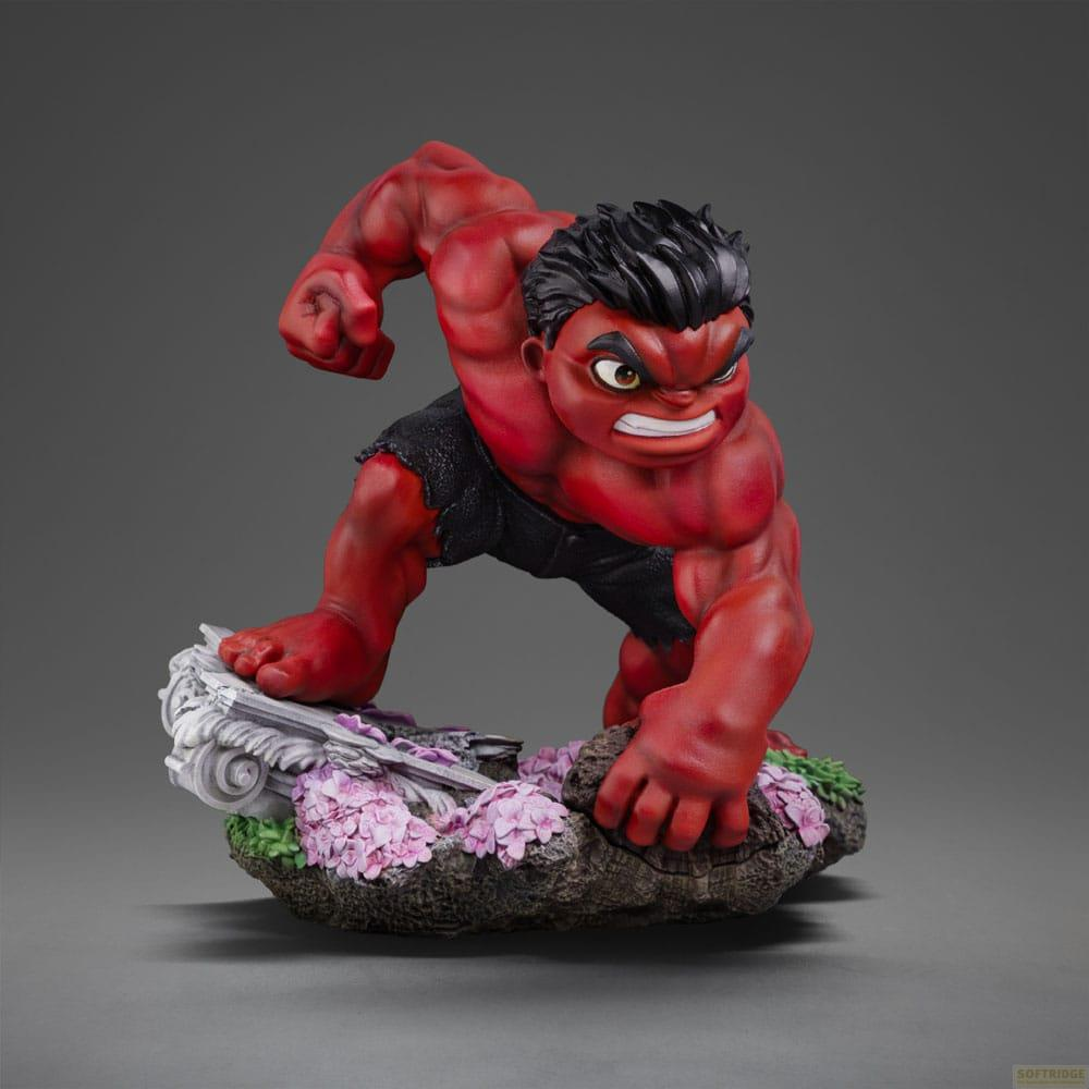 Statua di Red Hulk su base rocciosa con fiori rosa e muschio verde.