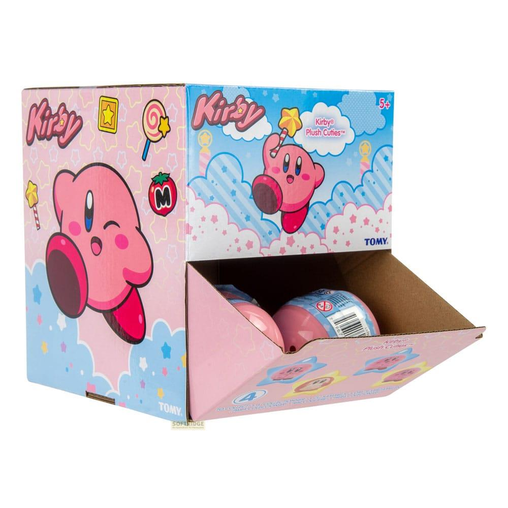 Une boîte d'exposition en peluche rose Kirby avec des images de Kirby et de nuages.