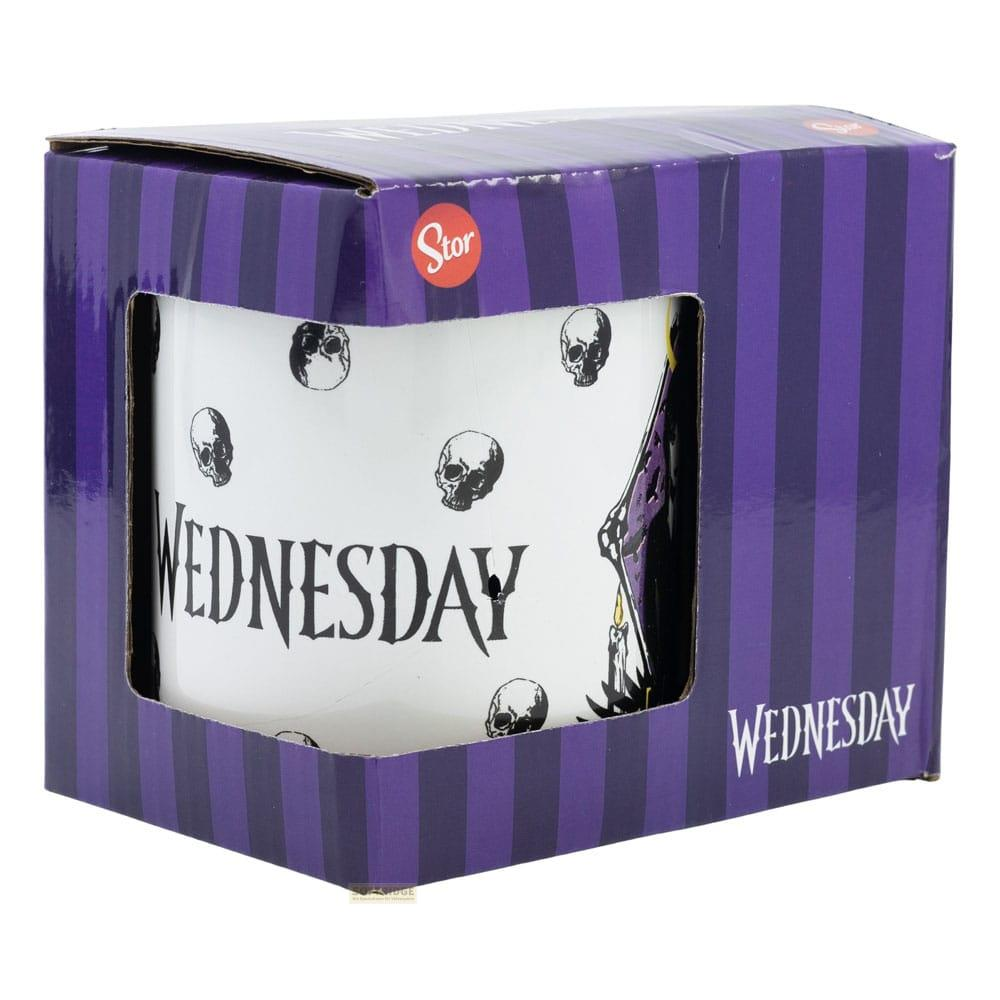 Una taza blanca con calaveras y la palabra "WEDNESDAY", en una caja a rayas moradas.