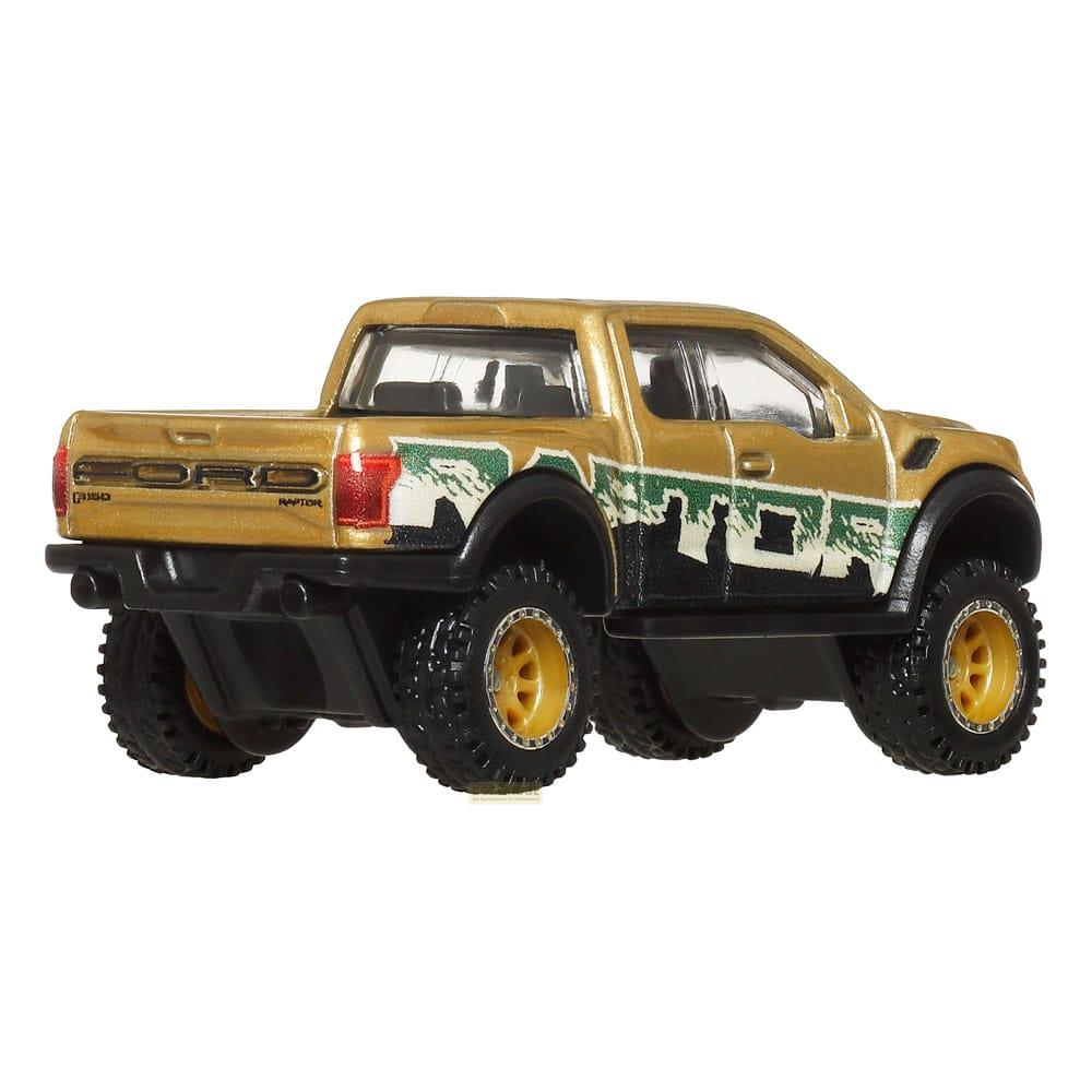 Goldener Ford Raptor Spielzeug-LKW mit schwarzen Akzenten und grünen Berg-Grafiken.