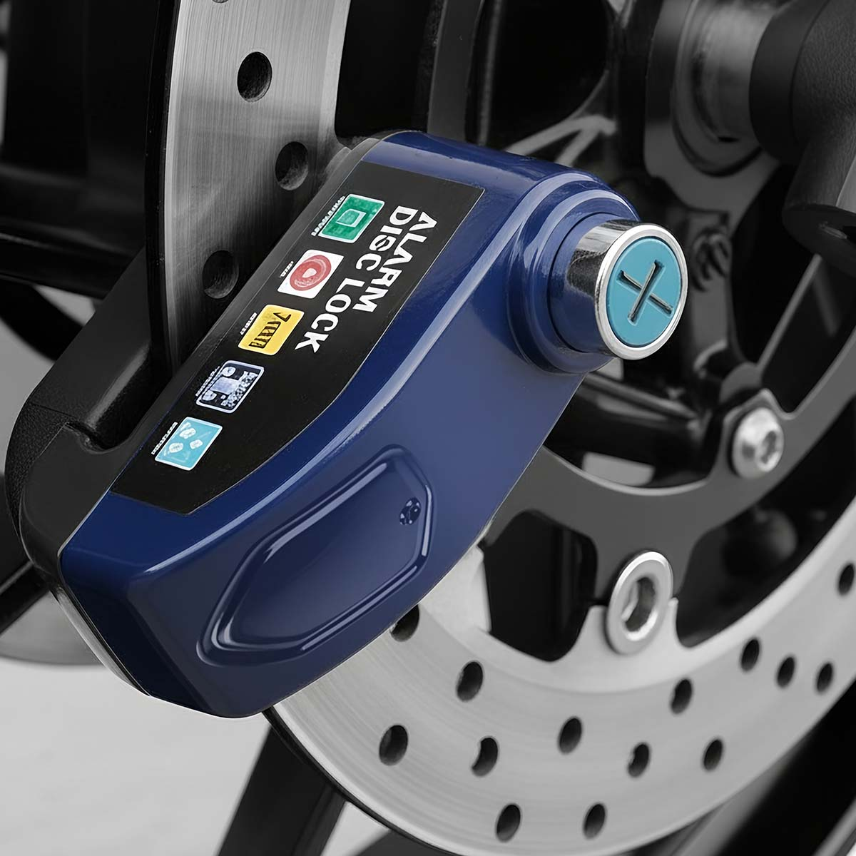Blaues Alarm-Scheibenschloss an einer Motorradbremsscheibe mit sichtbaren Perforationen.