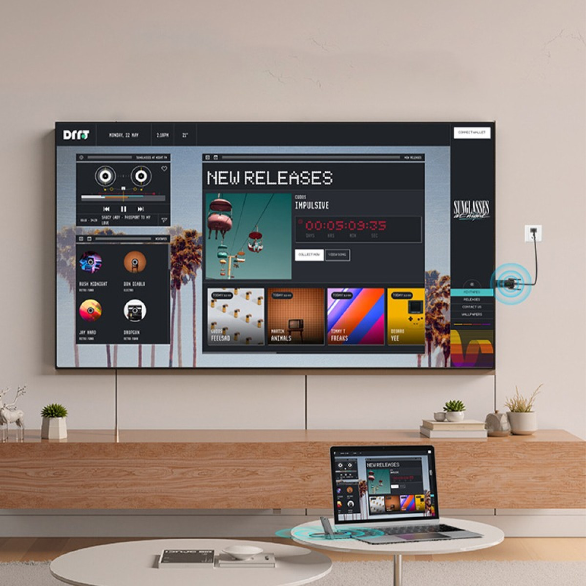 Ein großer Fernseher zeigt eine neue Veröffentlichungs-App mit Spielen und Musik. Ein Laptop daneben.