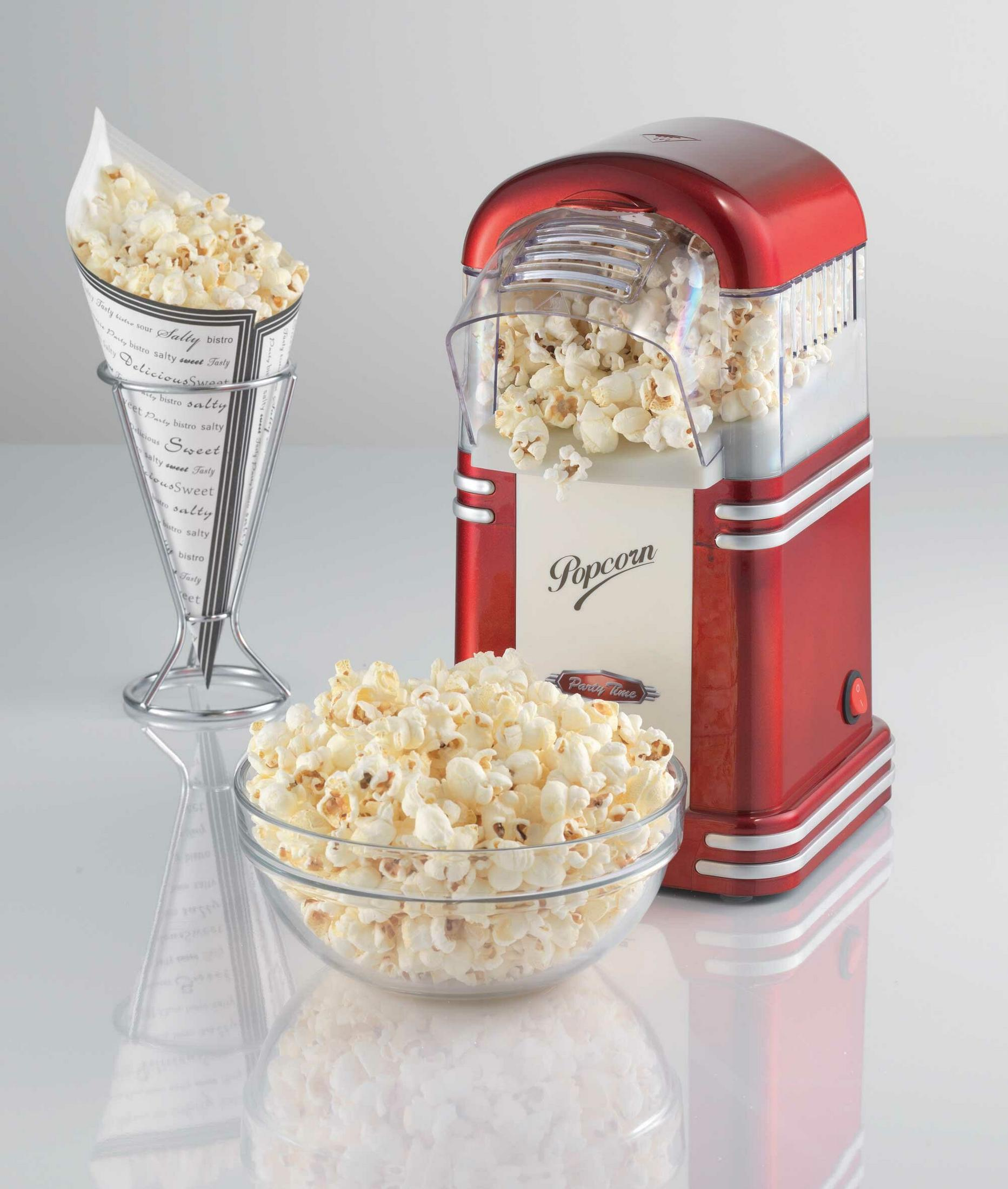 Una macchina per popcorn rossa con ciotola e cono di popcorn.