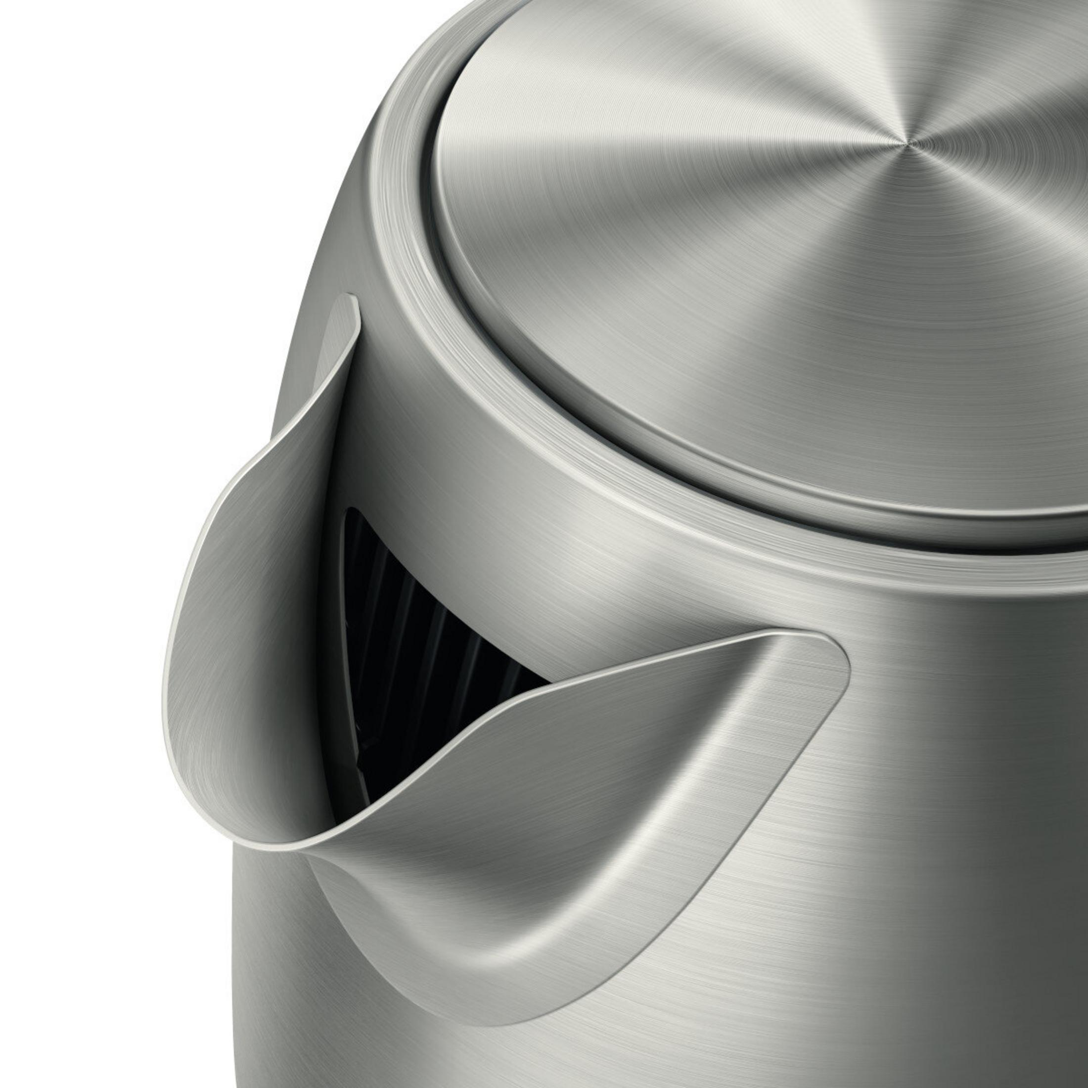 Close-up of a silver kettle with a brushed metal finish and a spout.