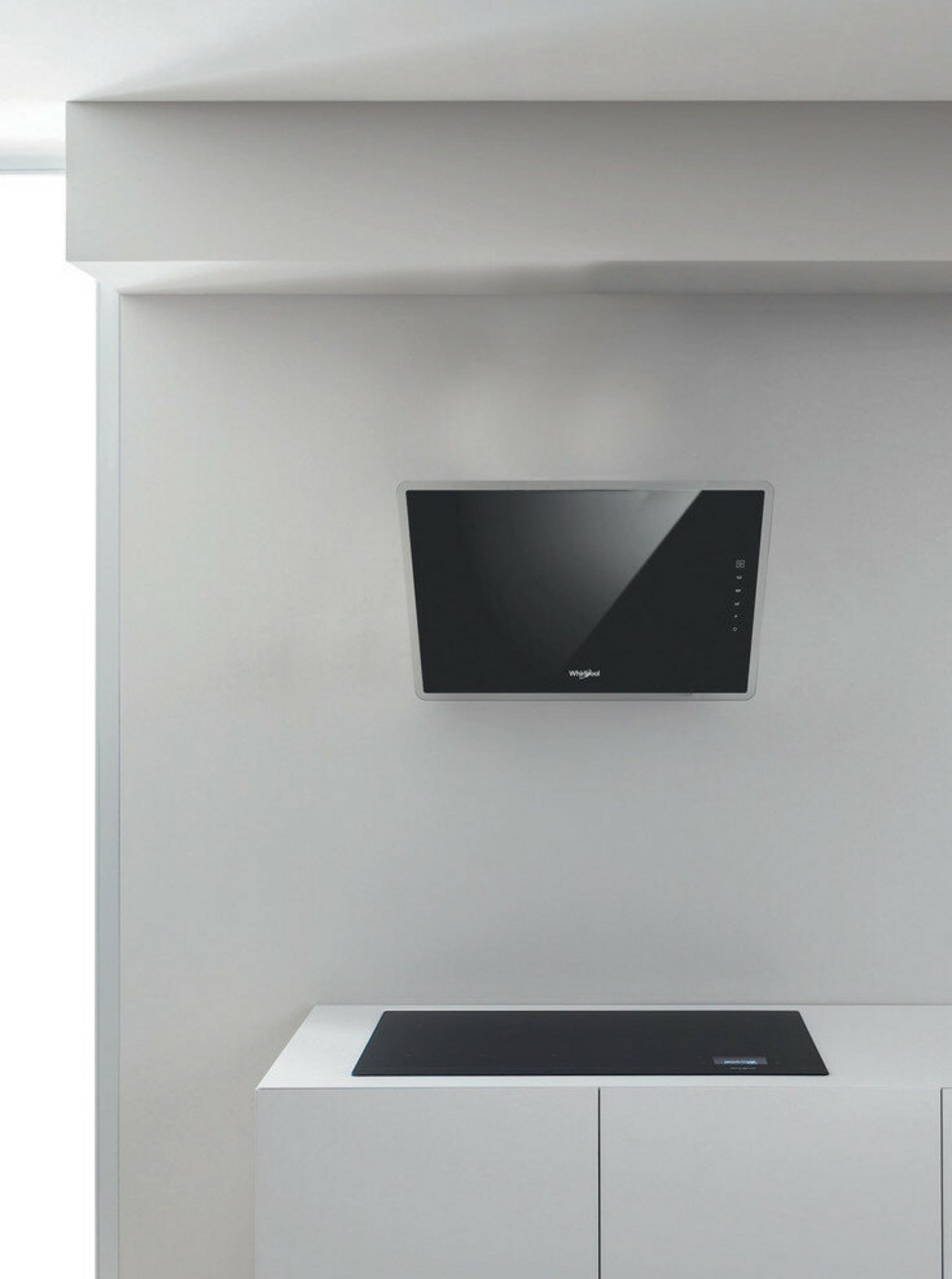 Een afzuigkap boven een kookplaat in een moderne keuken.