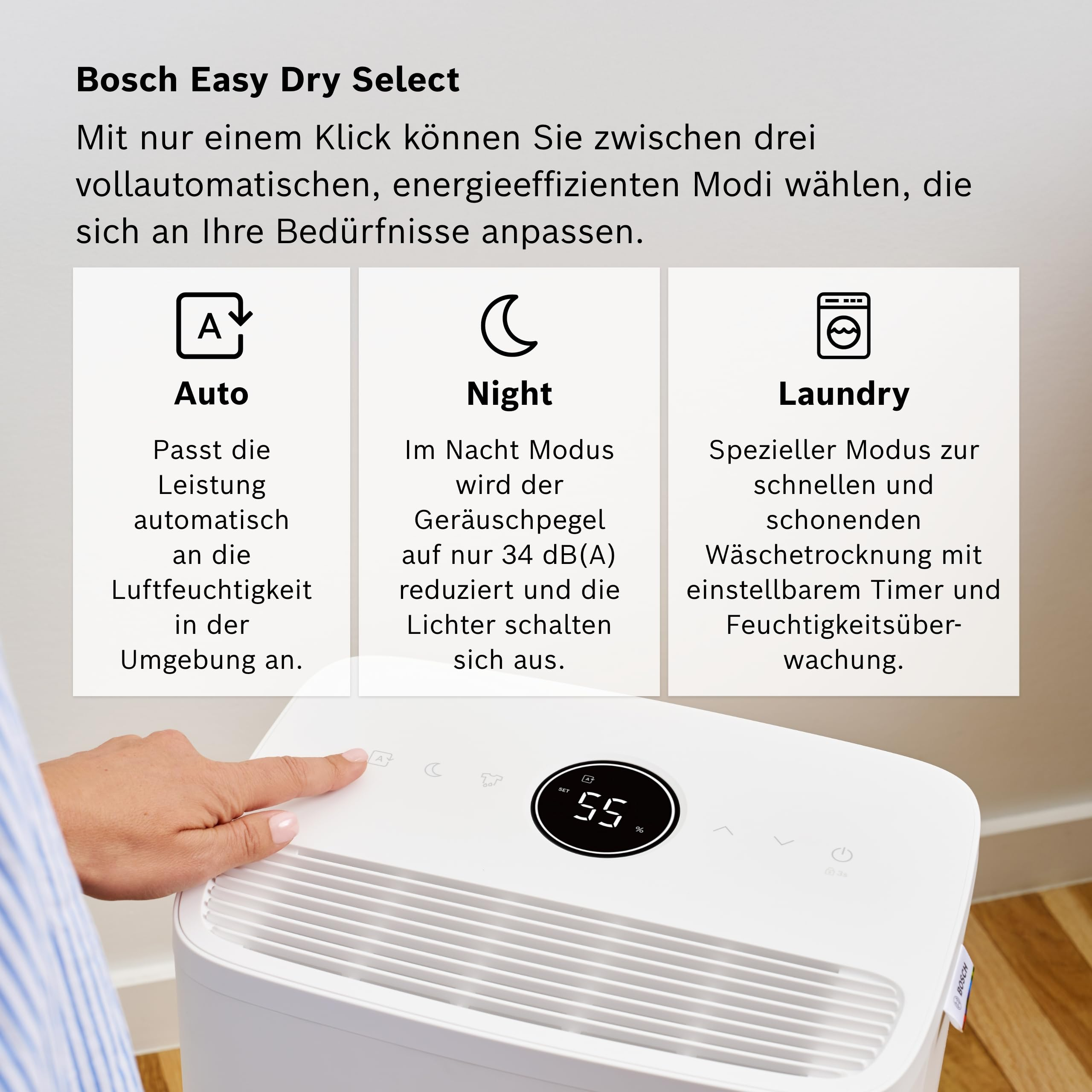 Ein Bosch Luftentfeuchter mit drei Modi: Auto, Nacht und Wäsche. Ein Finger berührt das Gerät.