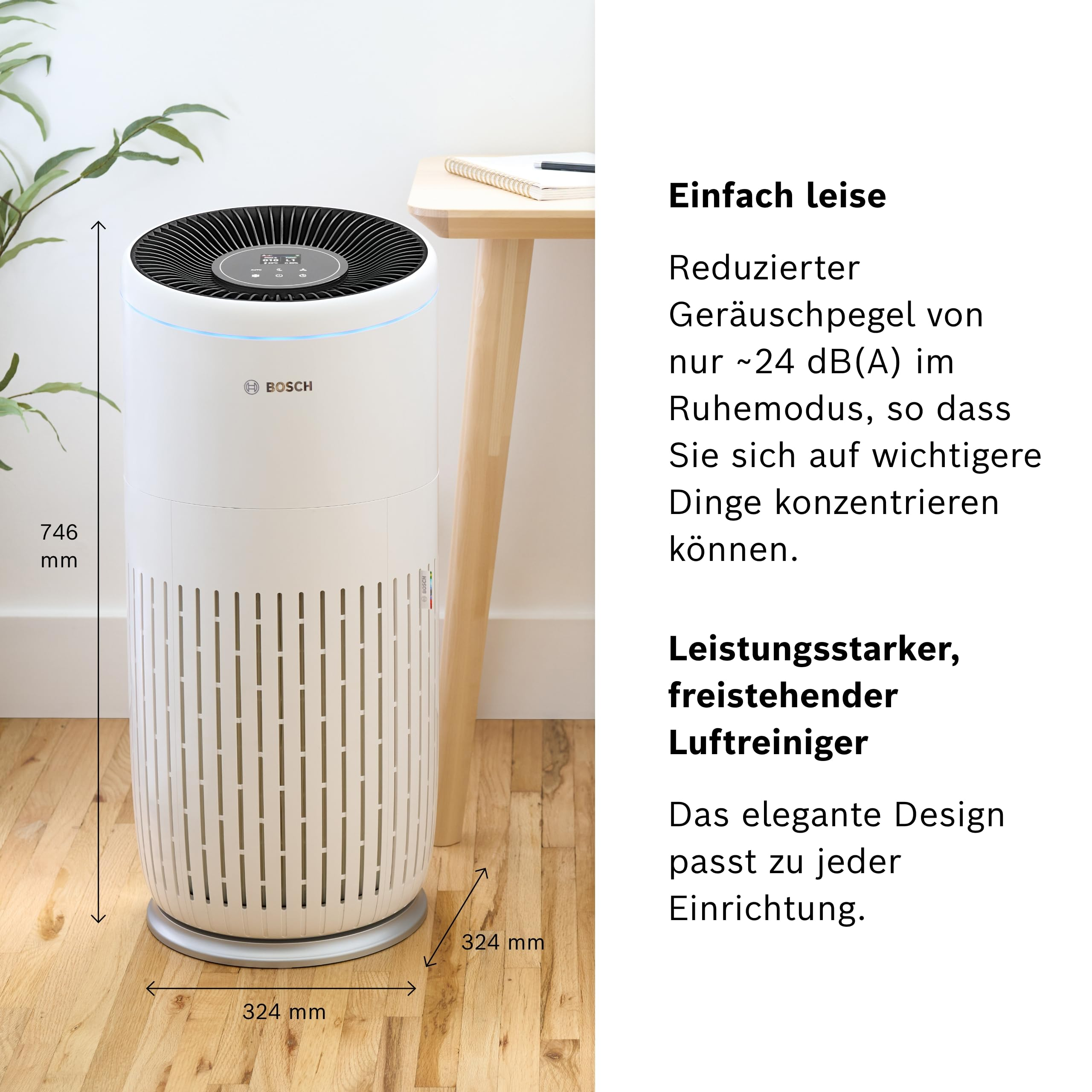 Ein weißer Bosch Luftreiniger steht auf einem Holzboden neben einem Tisch.