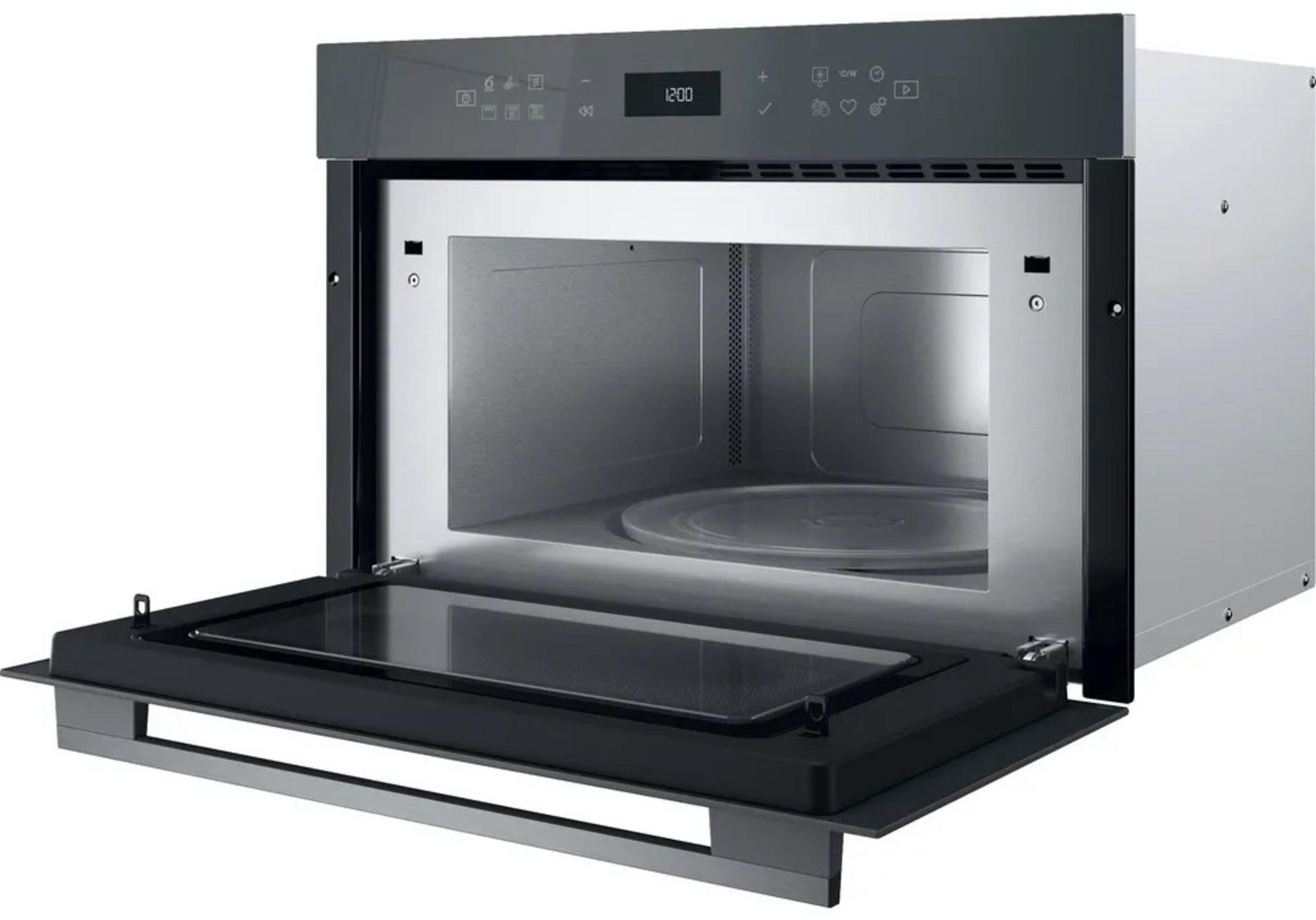 Open modern stainless steel microwave with digital display and glass turntable.