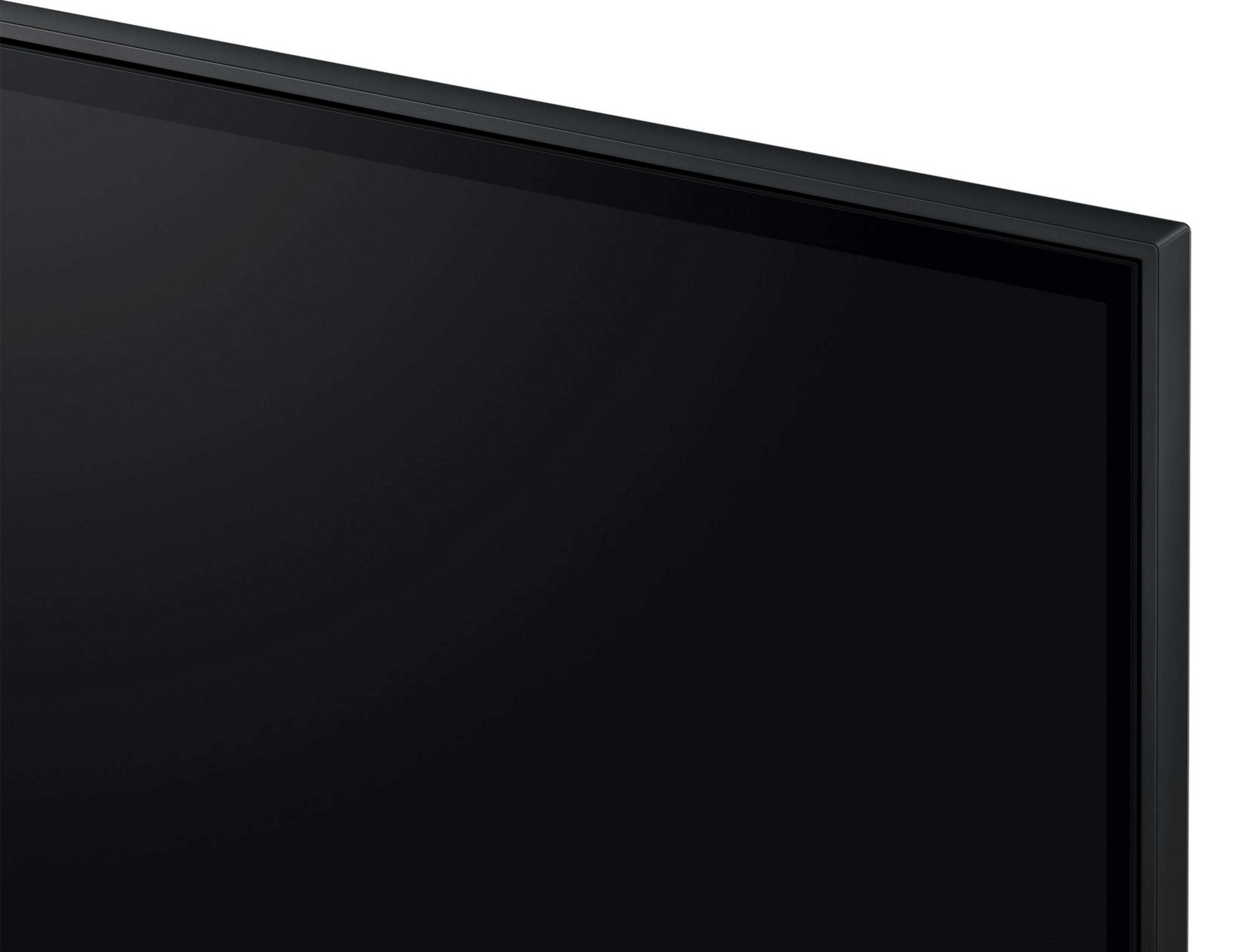 Primo piano del bordo di una TV a schermo piatto nera con cornice sottile.