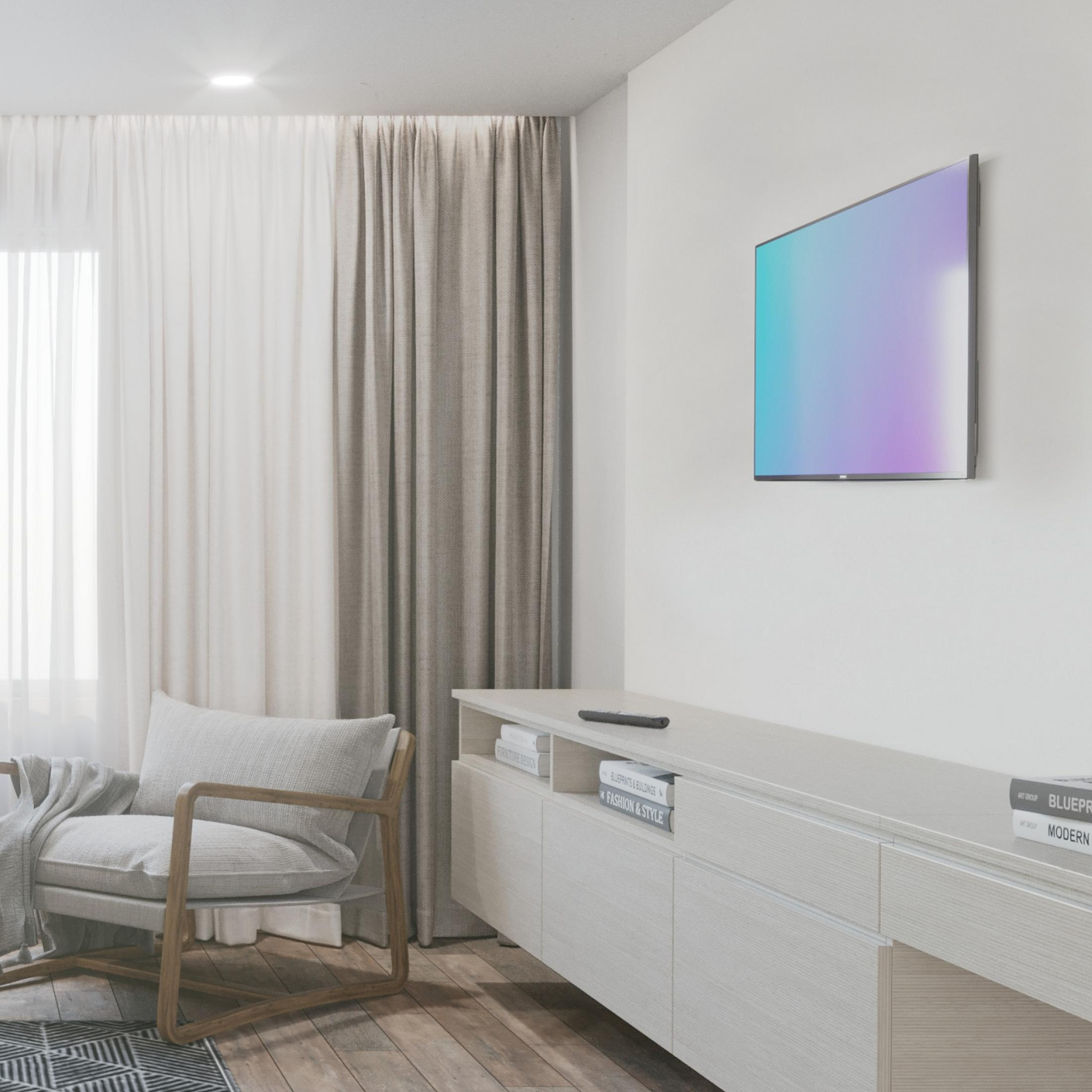 Una sala de estar moderna con sillón, TV y un largo mueble blanco.