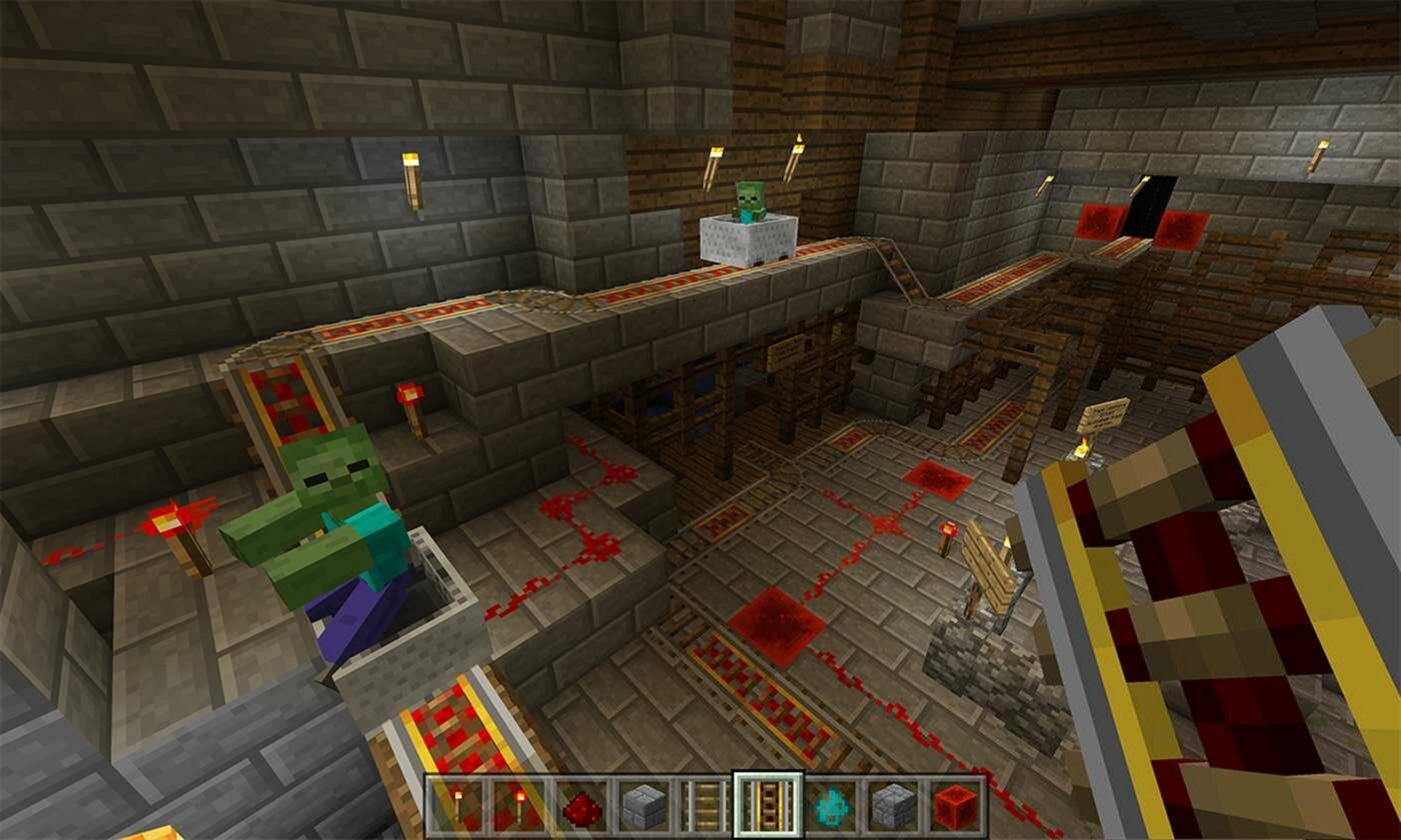 Binarie per vagoncini Minecraft con zombie e lampade di redstone in un sotterraneo di mattoni di pietra.