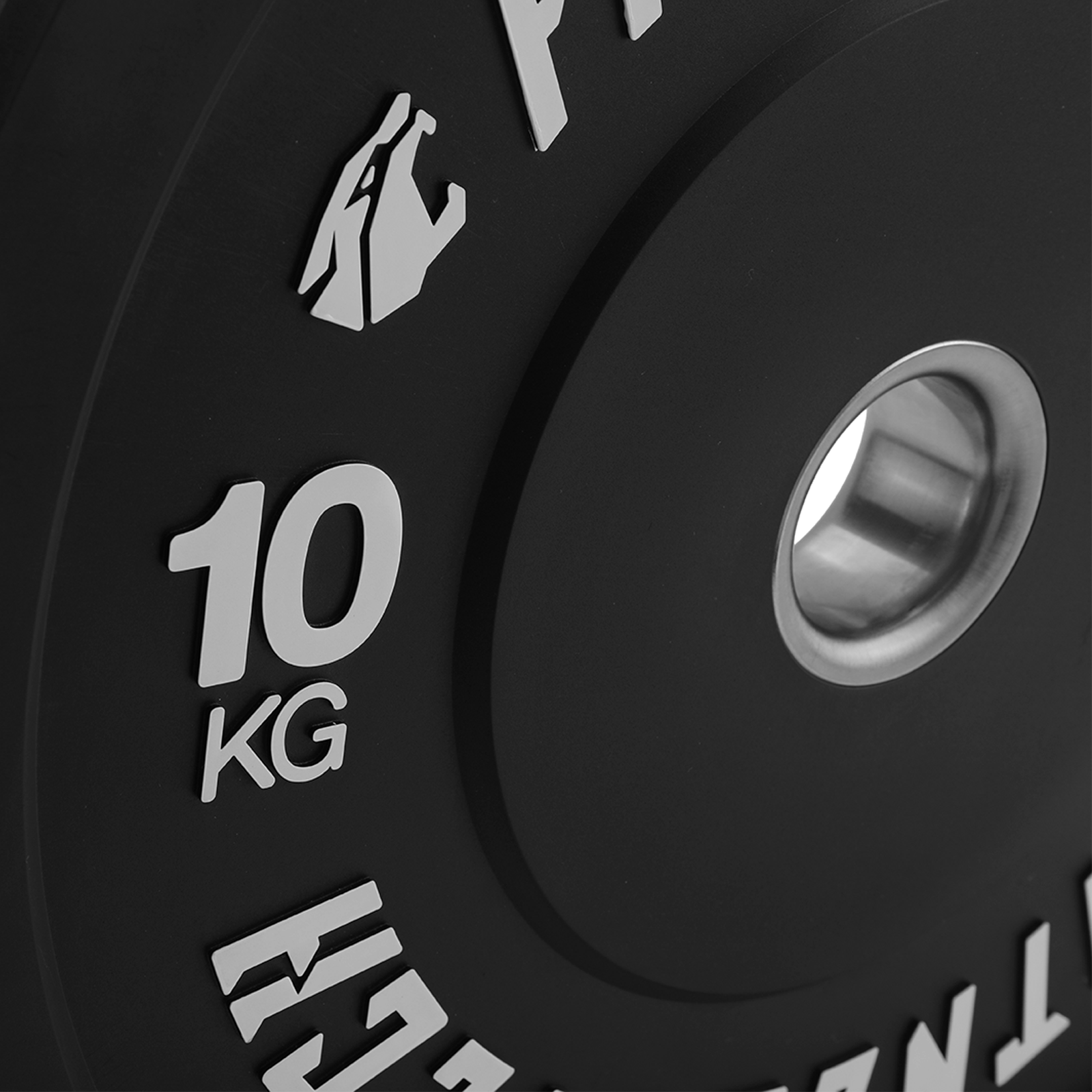 Placa de peso negra de 10 kg con texto plateado y un inserto de metal para la barra.