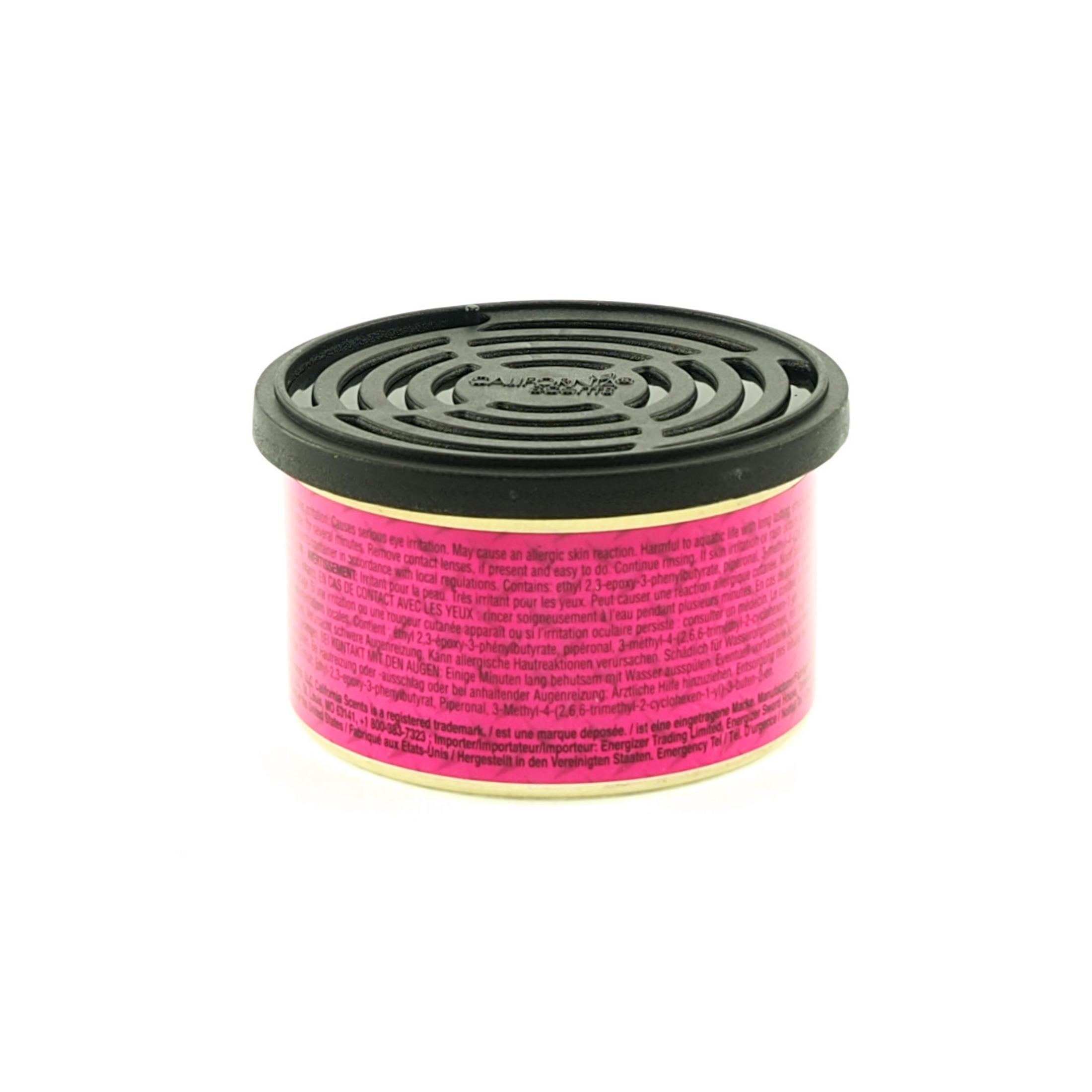 Ein Lufterfrischer mit schwarzem Gitter und rosa Etikett mit Warnhinweisen.