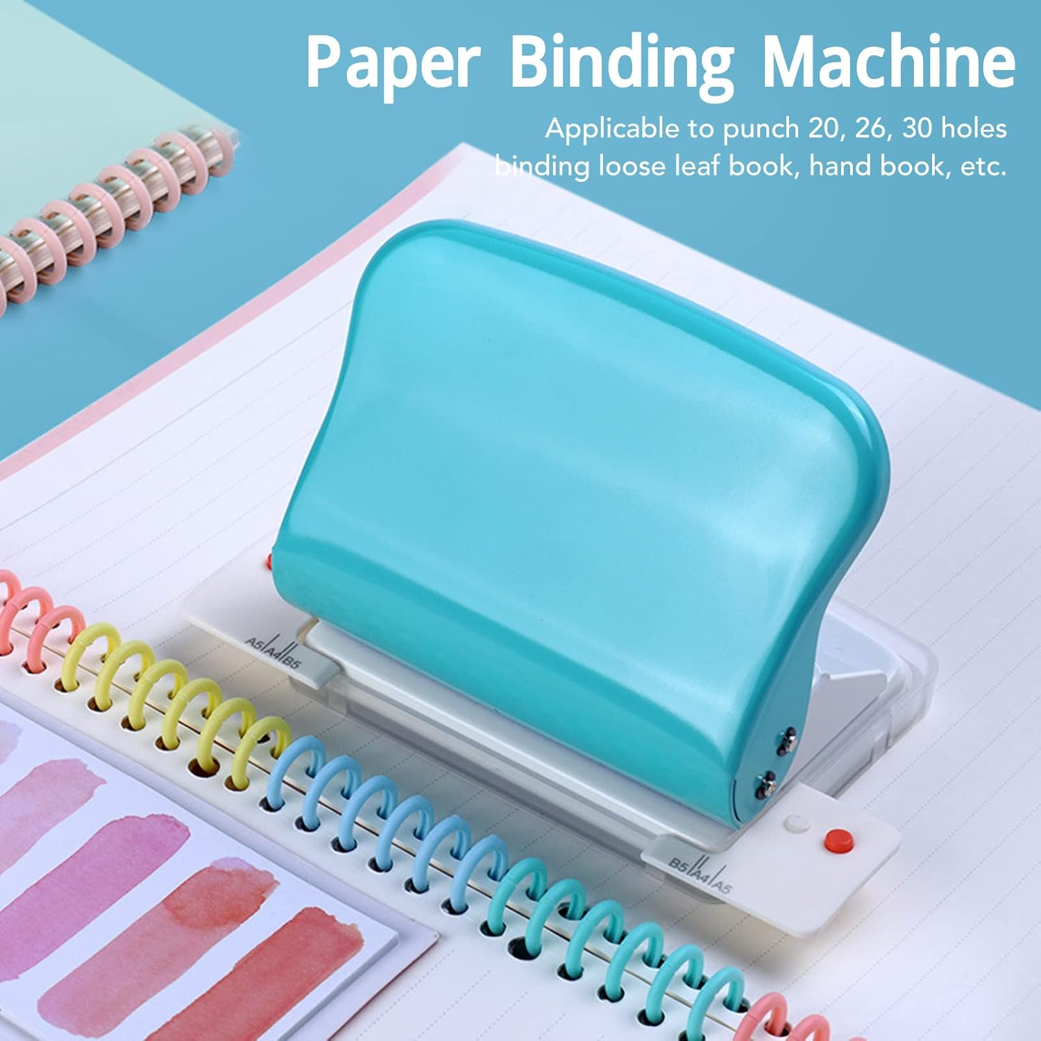 Türkisfarbene Papierbindemaschine auf Notizbuch mit bunten Spiralbindungen.
