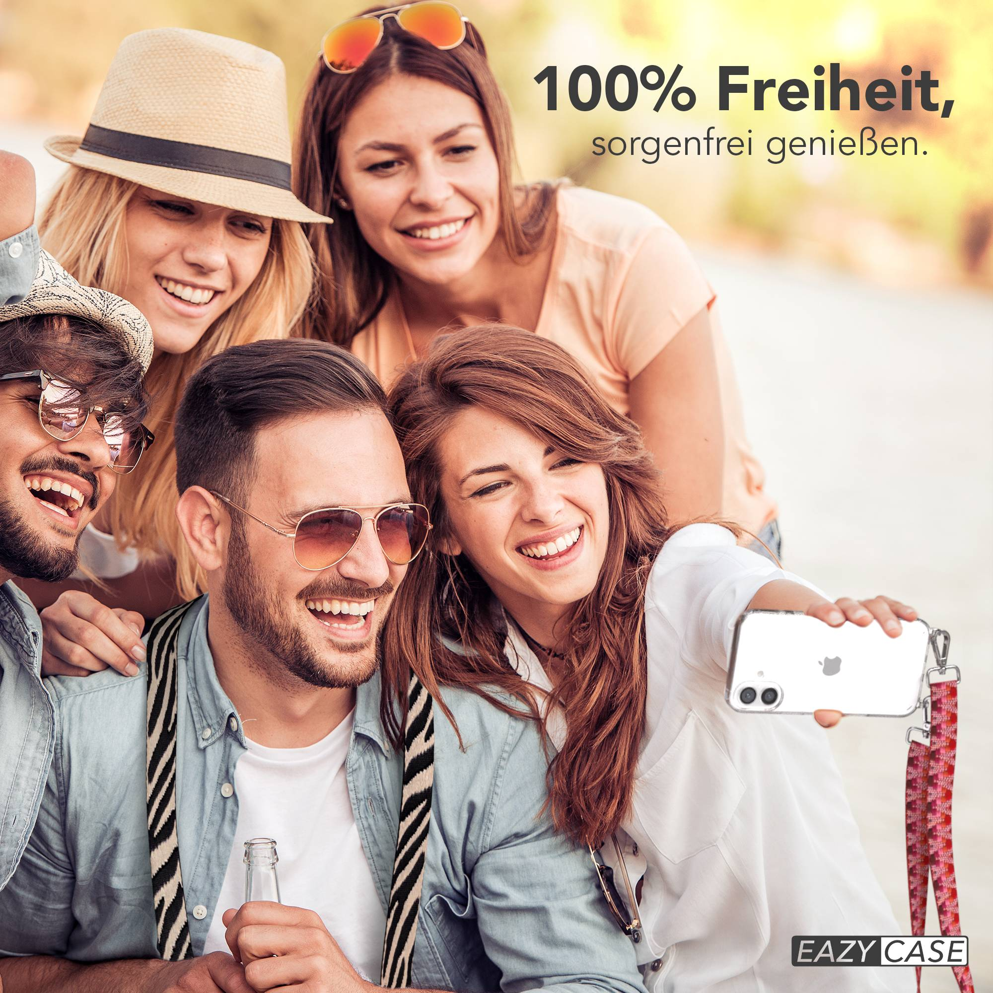 Fünf lachende Freunde machen ein Selfie im Freien. Eine Frau hält ein Handy.