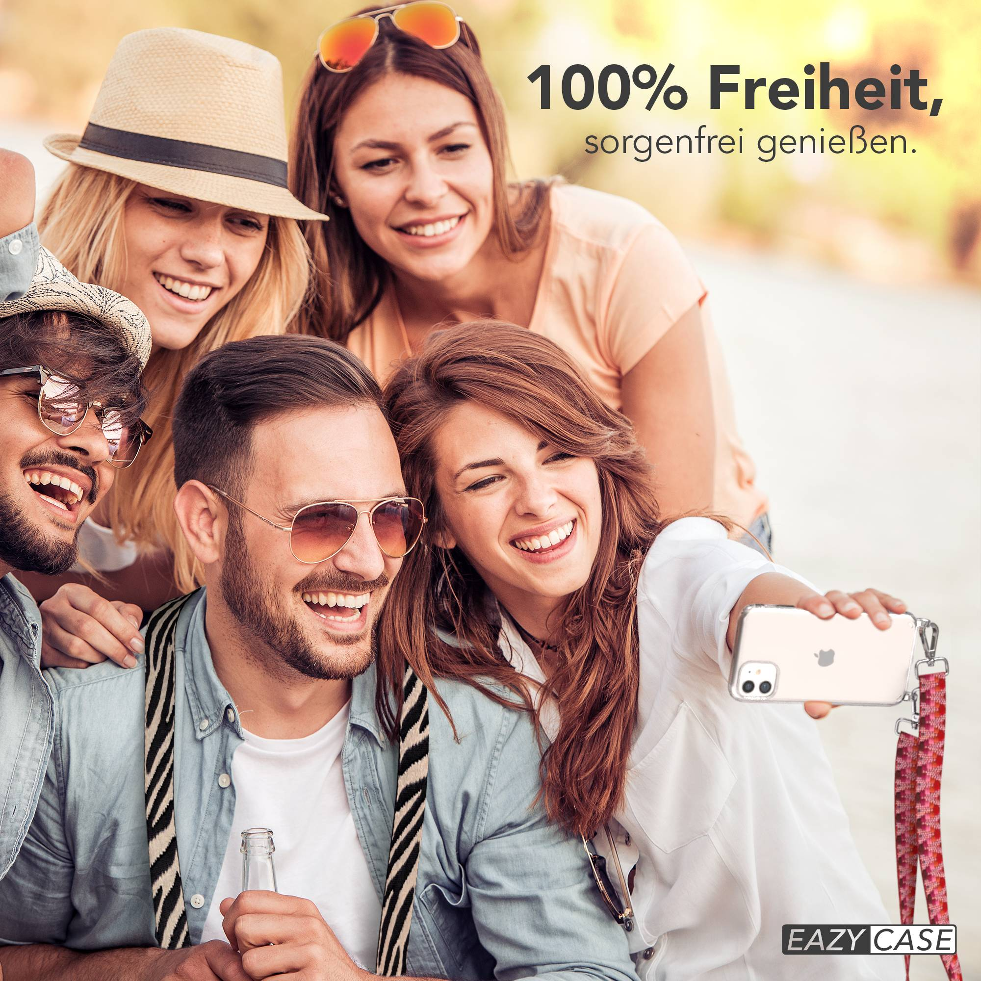 Vier junge Leute lächeln für ein Selfie, das von einer Frau mit einem Handy aufgenommen wurde.