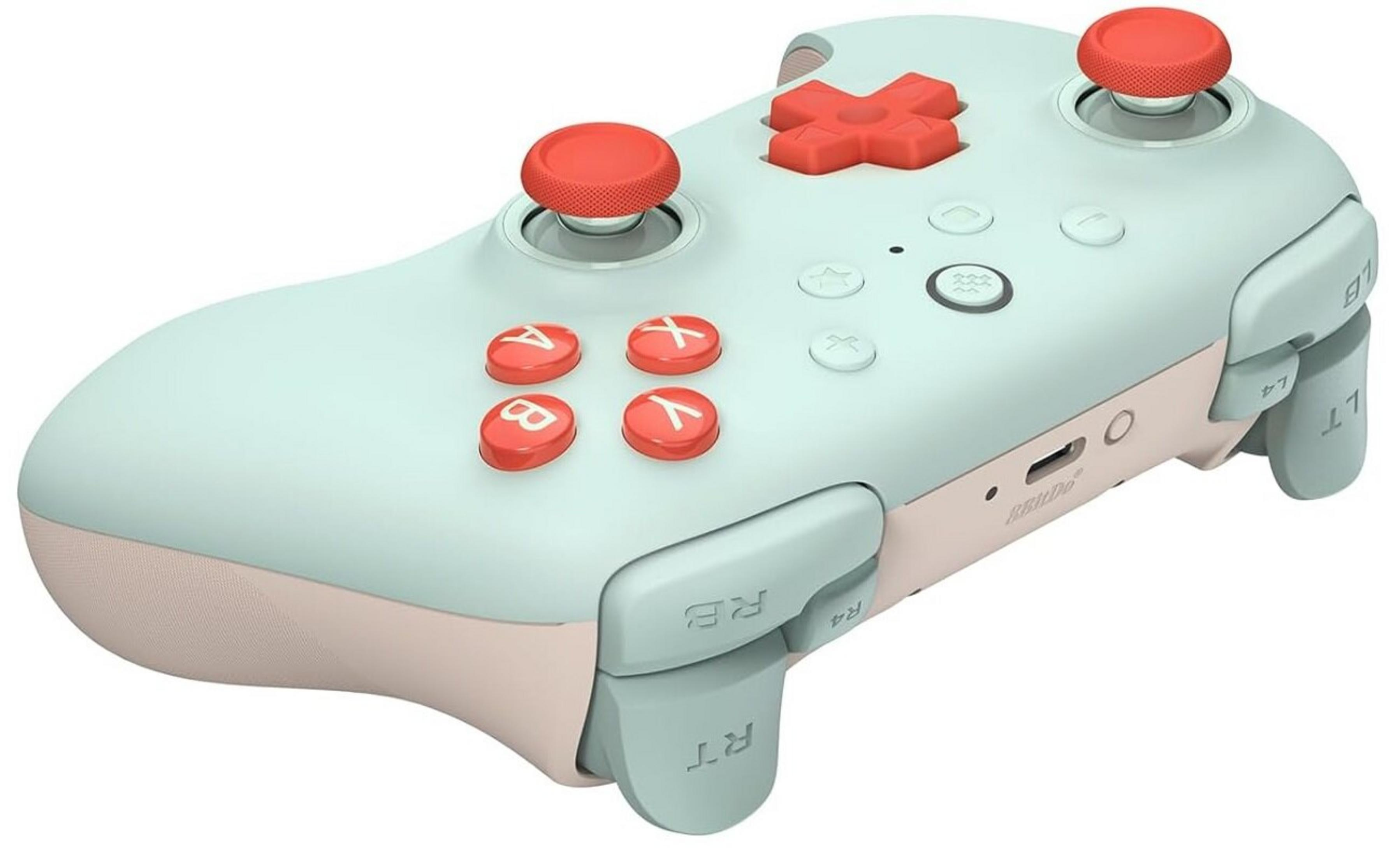 Jasnoniebieski i różowy kontroler do gier z czerwonymi przyciskami i joystickami.