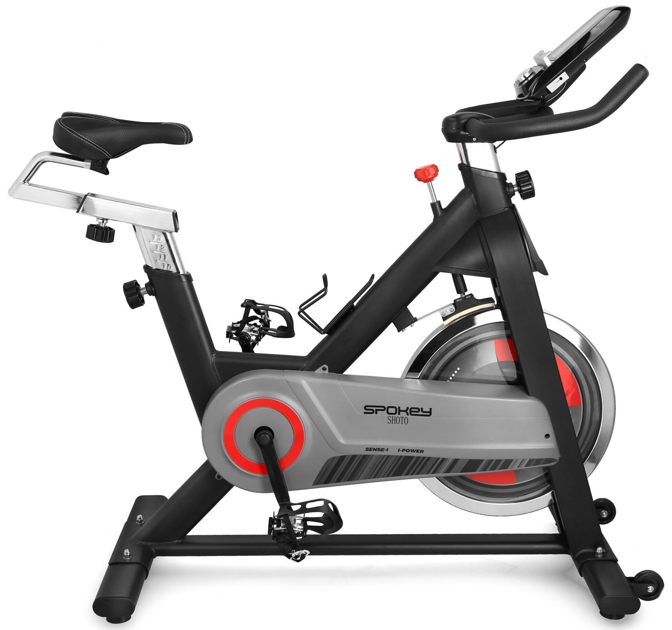 Una bicicleta de ejercicio negra y gris con pantalla digital y detalles rojos.