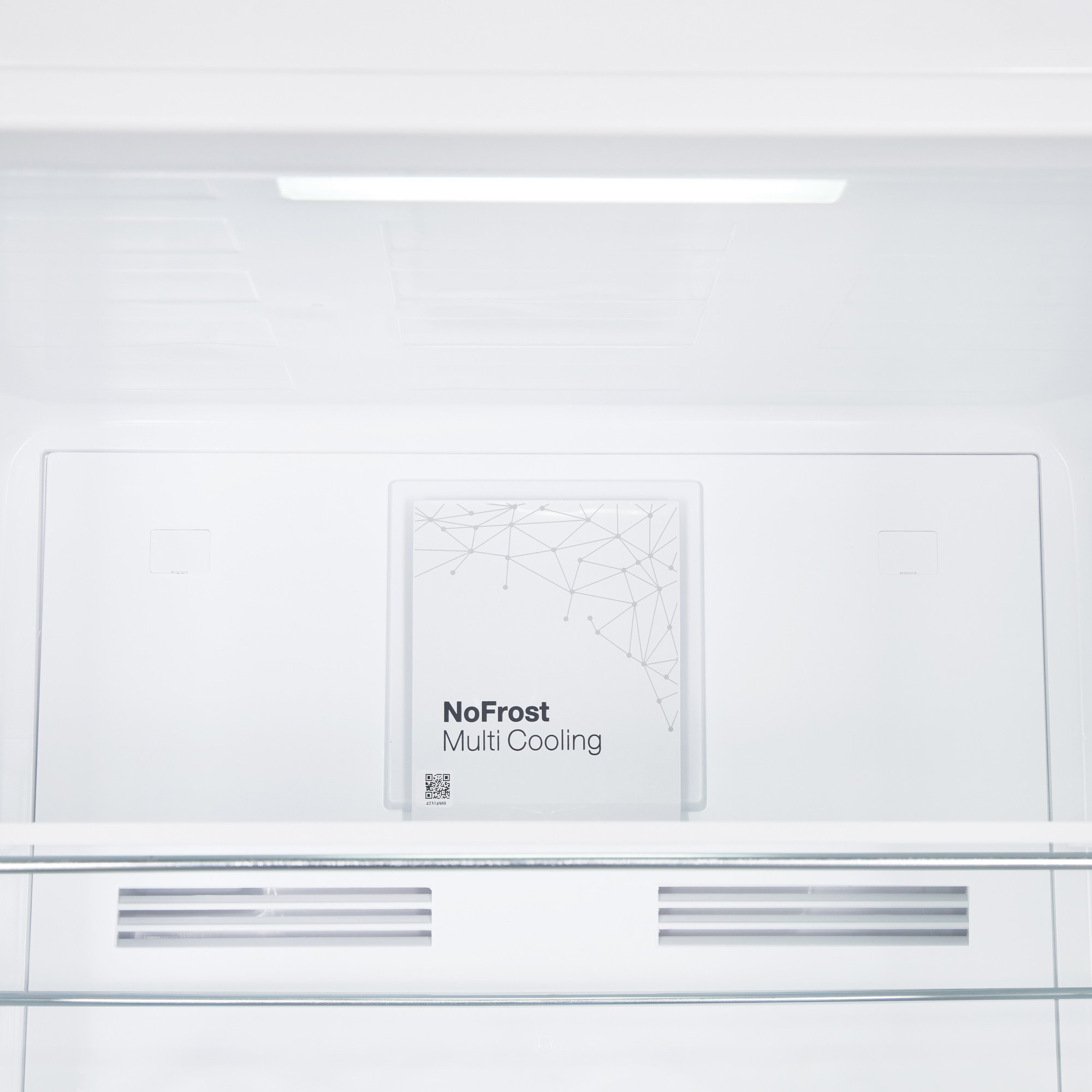 Interior of a refrigerator with NoFrost Multi Cooling label.