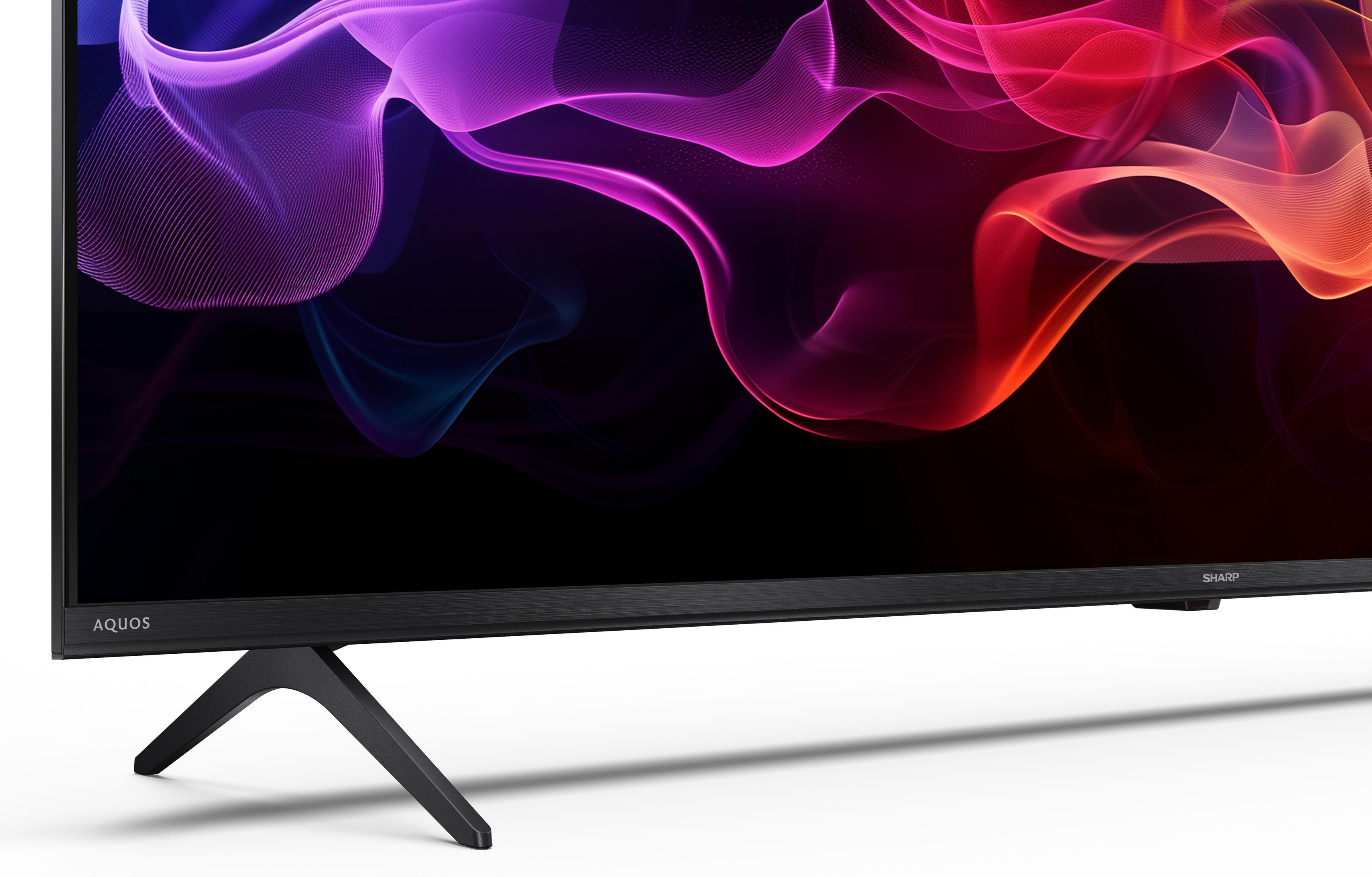 Een moderne flatscreen-tv met een abstracte, gloeiende paarse en rode achtergrond.
