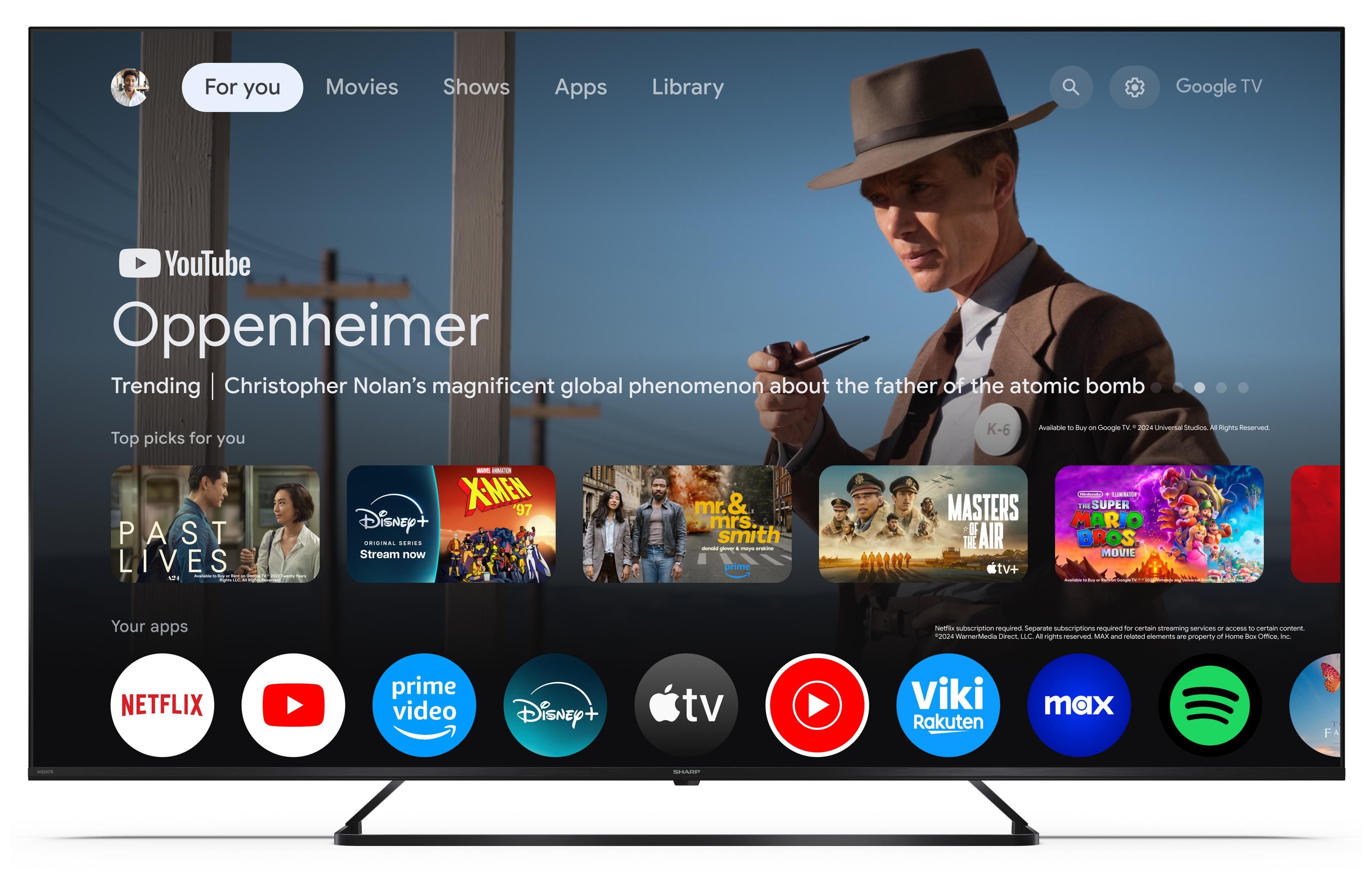 Google TV-Startbildschirm mit "Oppenheimer"-Poster, Filmauswahl und App-Symbolen.
