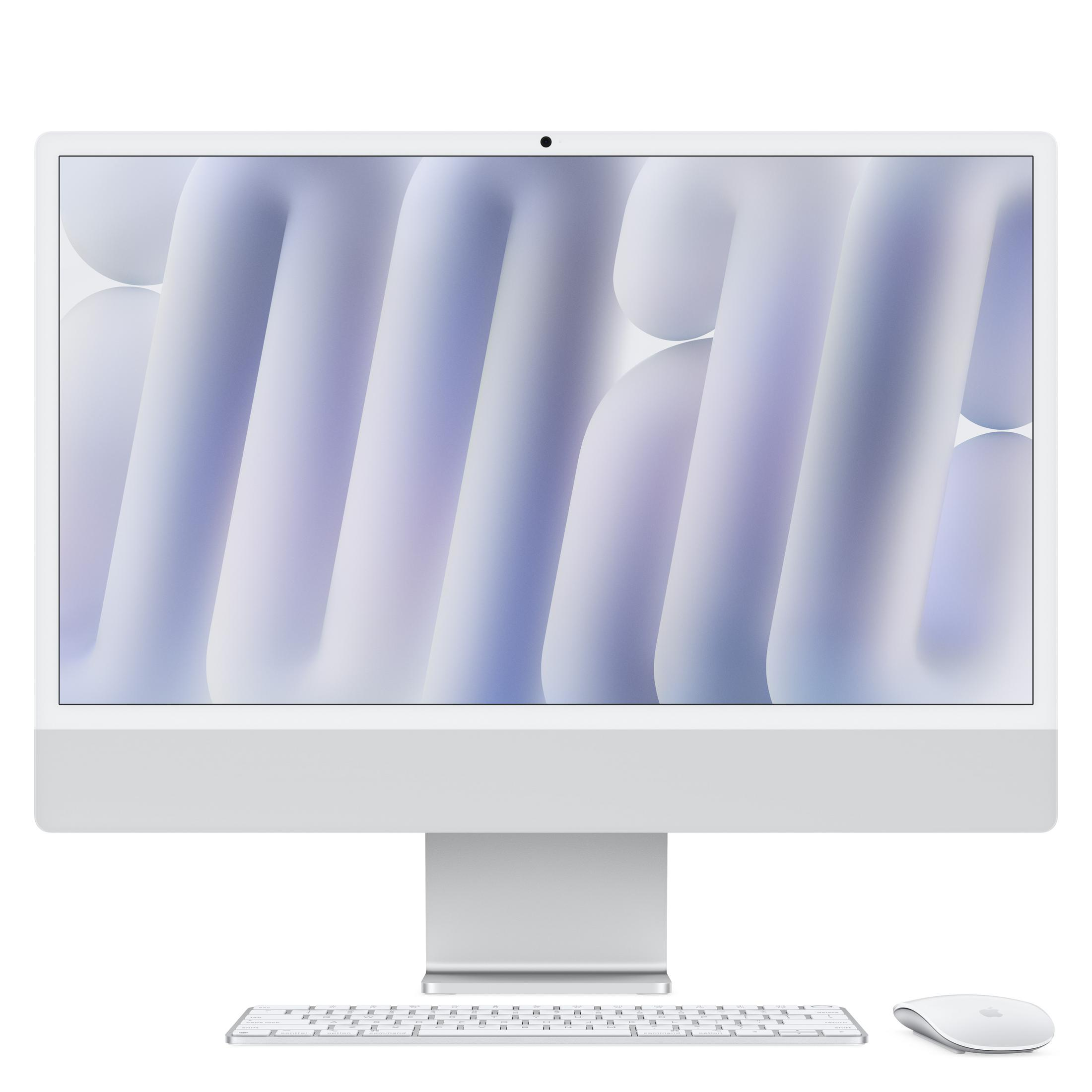 Un iMac argentato con tastiera e mouse su sfondo bianco.