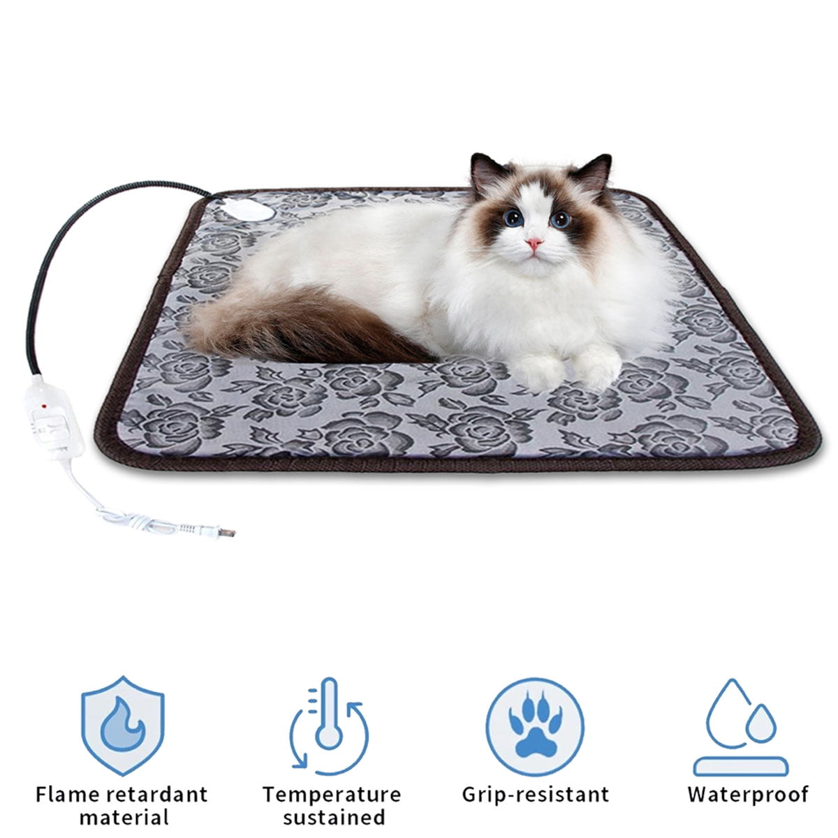 Eine Ragdoll-Katze liegt auf einer blumigen Heizmatte mit Stromkabel.