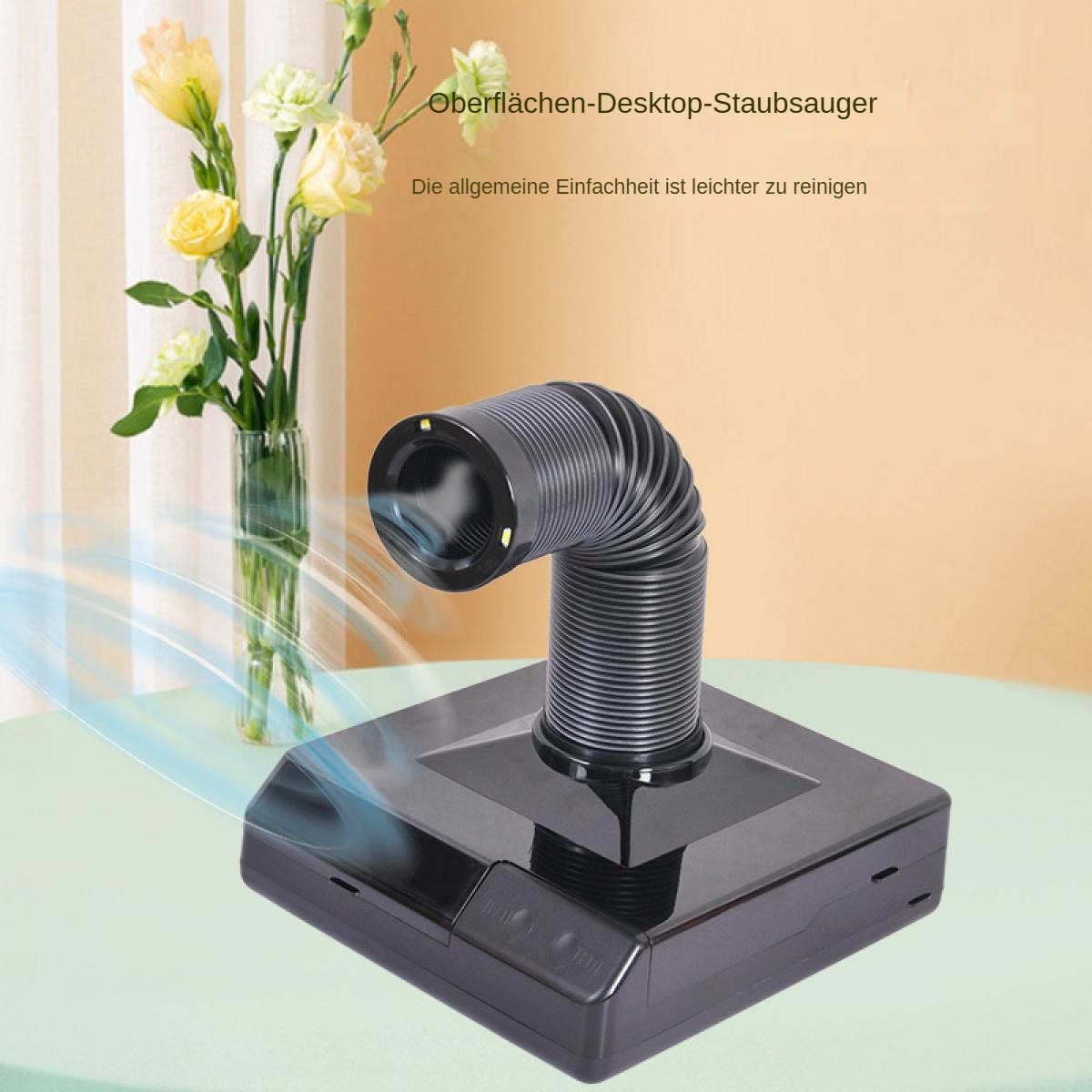 Ein schwarzer Desktop-Staubsauger mit flexibler Düse und Blumenstrauß.
