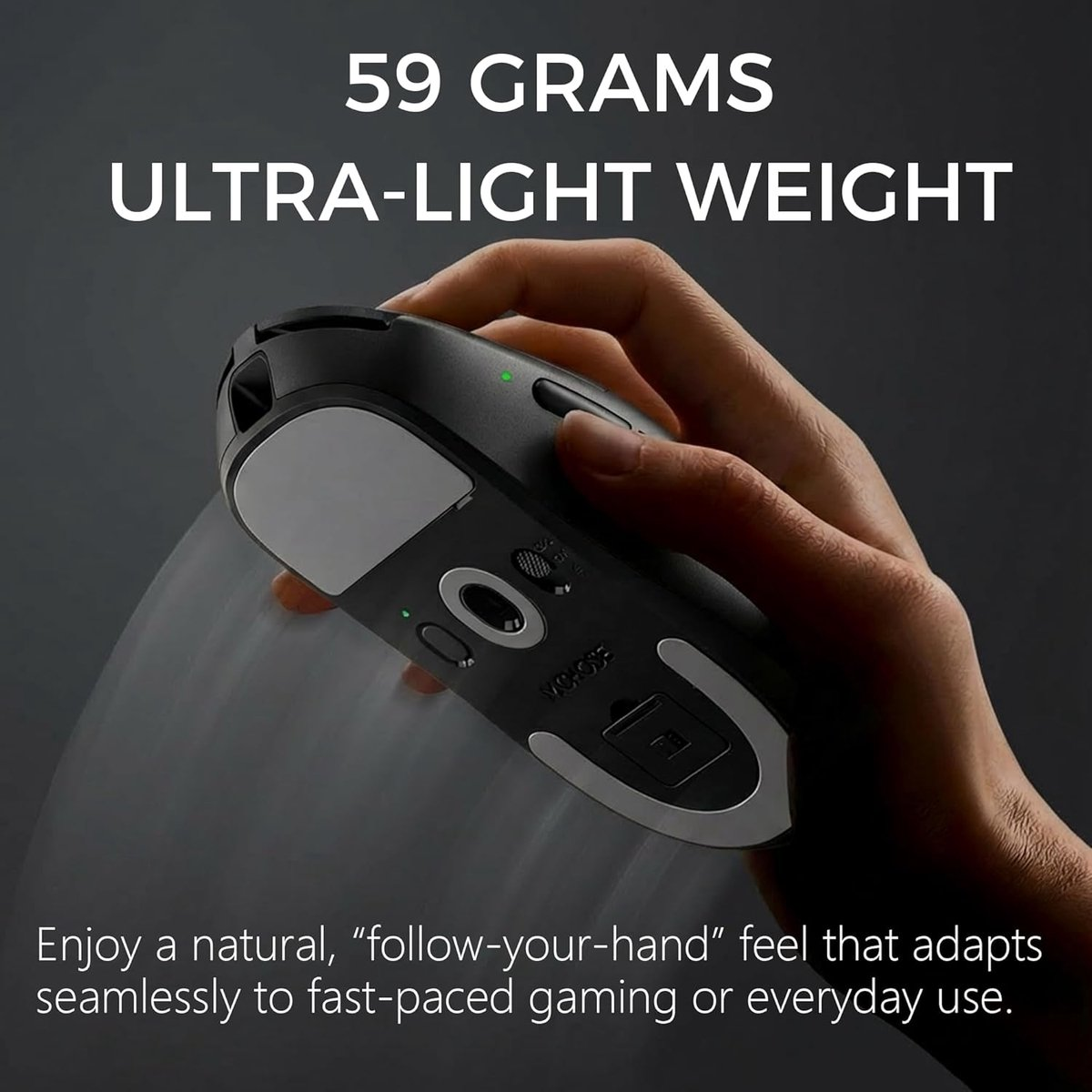 A hand holds a lightweight black mouse with gray accents and green lights.