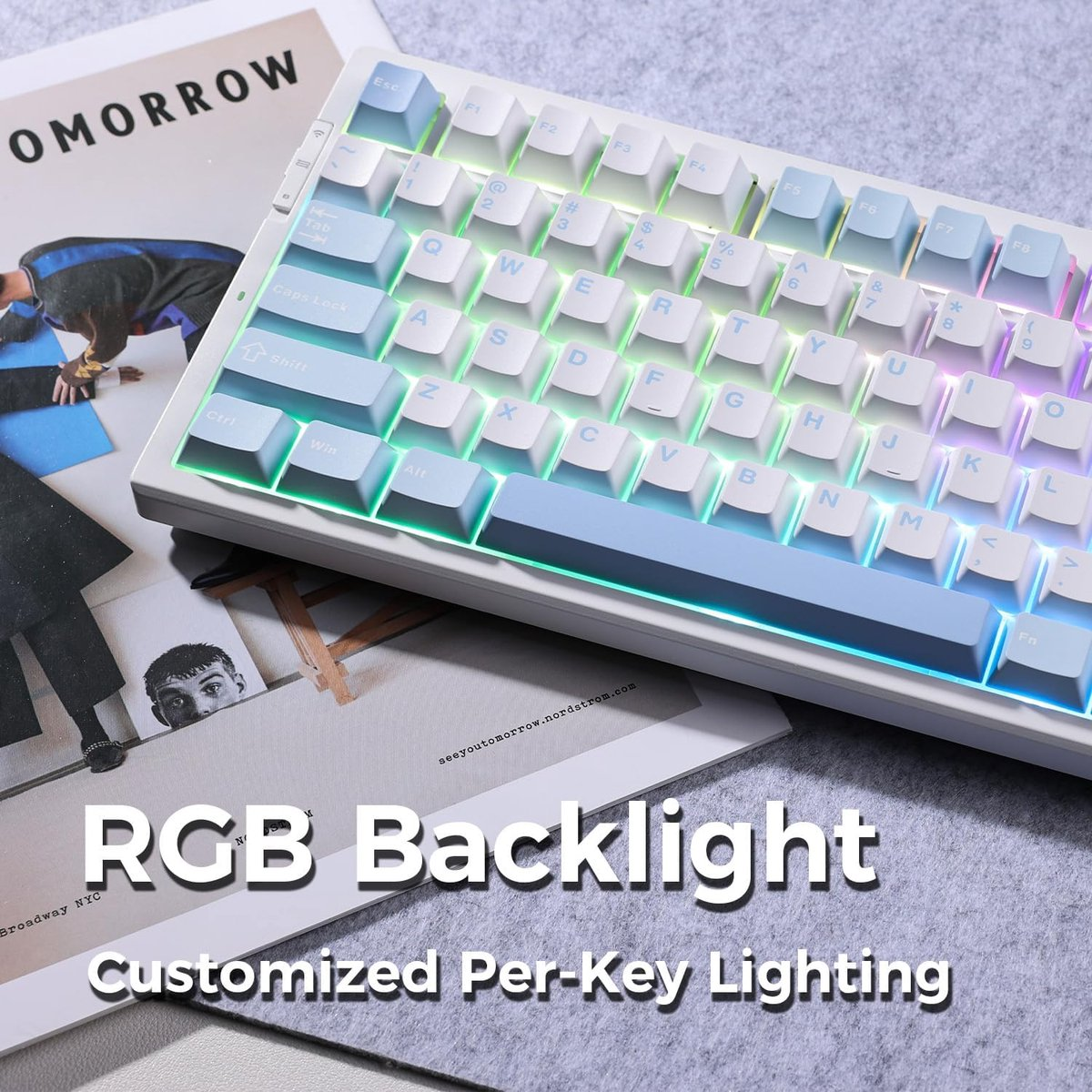 White RGB mechanical keyboard with customizable per-key lighting, on magazines.