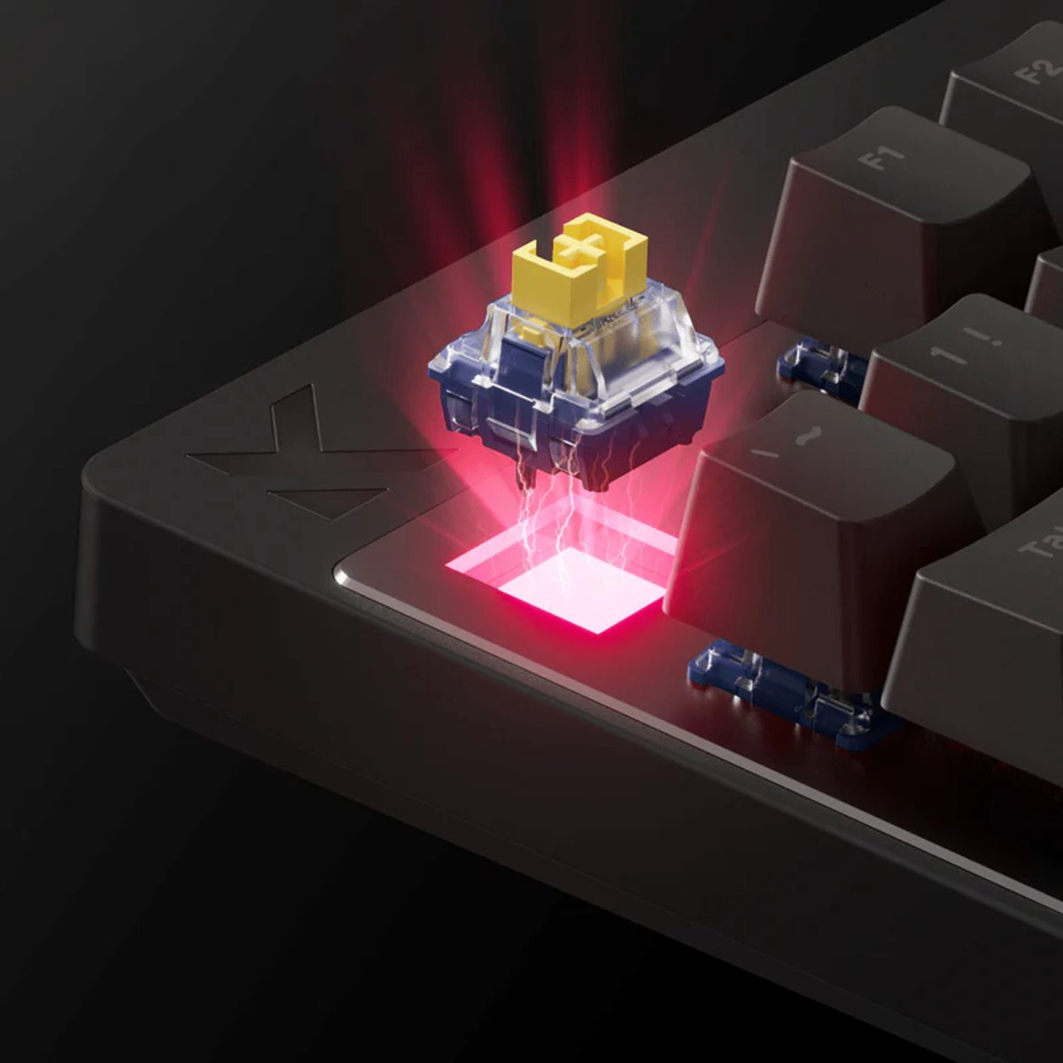 A yellow switch on a keyboard with red light effects.