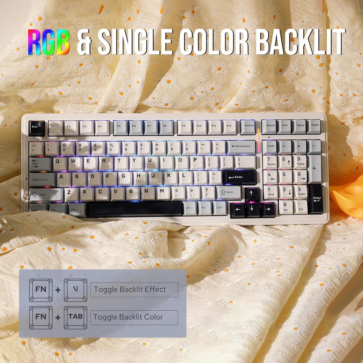 A white keyboard with RGB and single color backlighting on a patterned fabric.