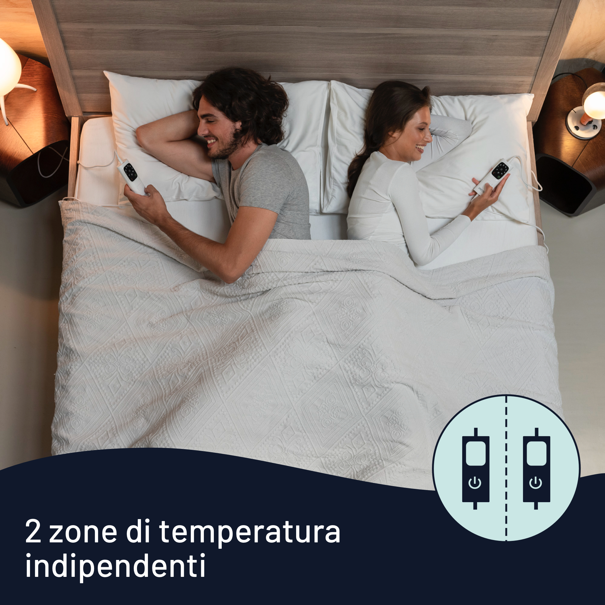 Una pareja yace en la cama sosteniendo controles remotos, mostrando dos zonas de temperatura.