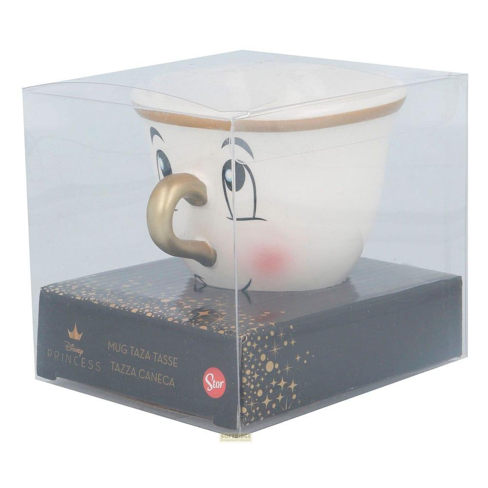 Une tasse blanche avec un visage, anse dorée, dans une boîte plastique.