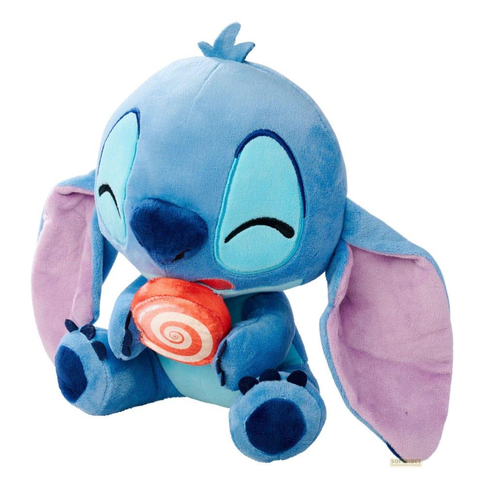 Ein blauer Stitch-Plüsch hält einen roten und weißen Lutscher.