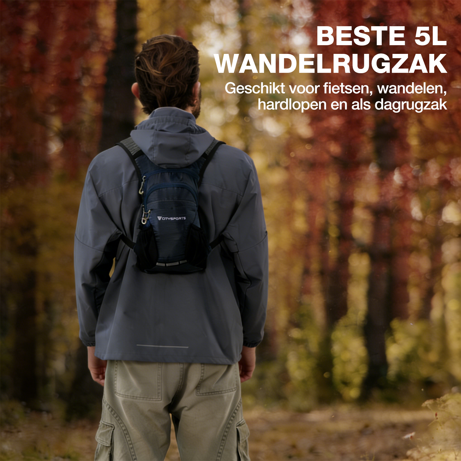 Man with backpack in forest, autumn colors in background.