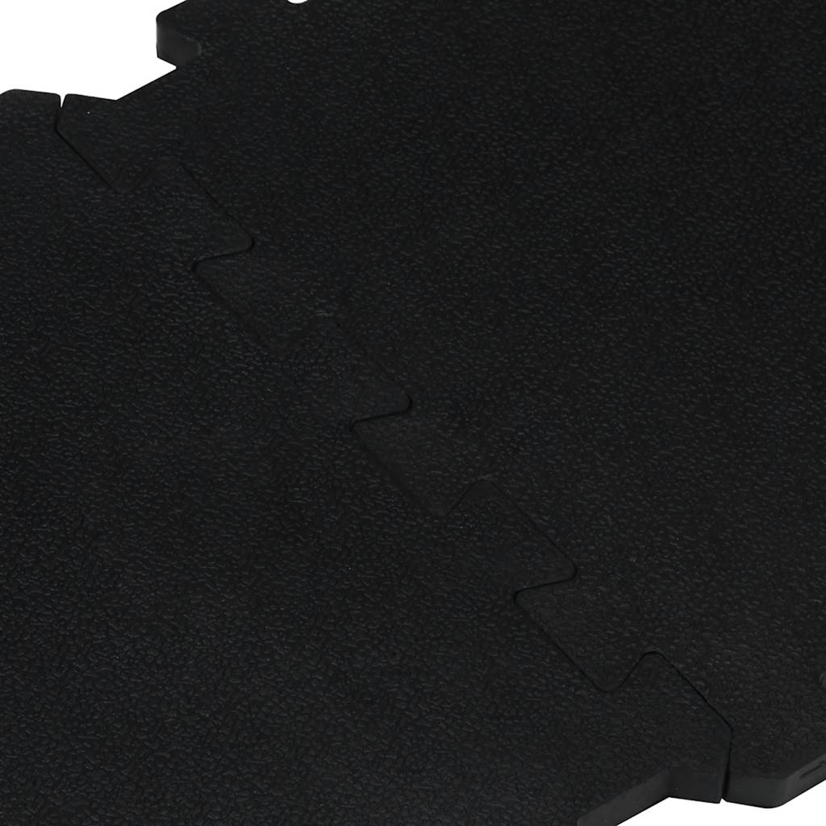 Schwarze Puzzle-Bodenfliesen mit einer strukturierten Oberfläche.