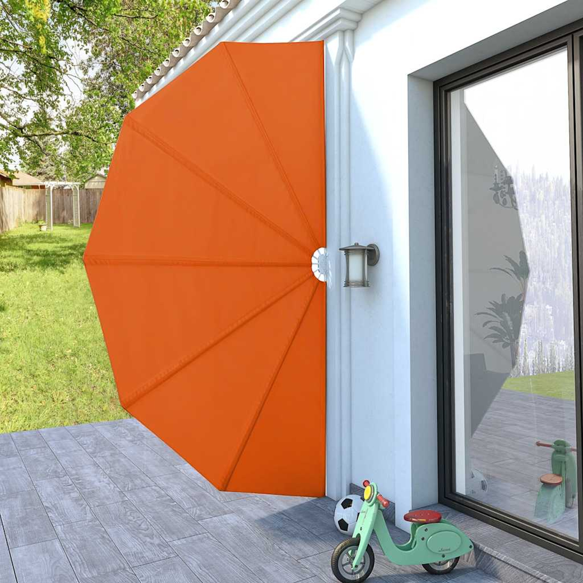 Orange Sonnenschirm-Markise an Hauswand, daneben ein Roller und Ball.