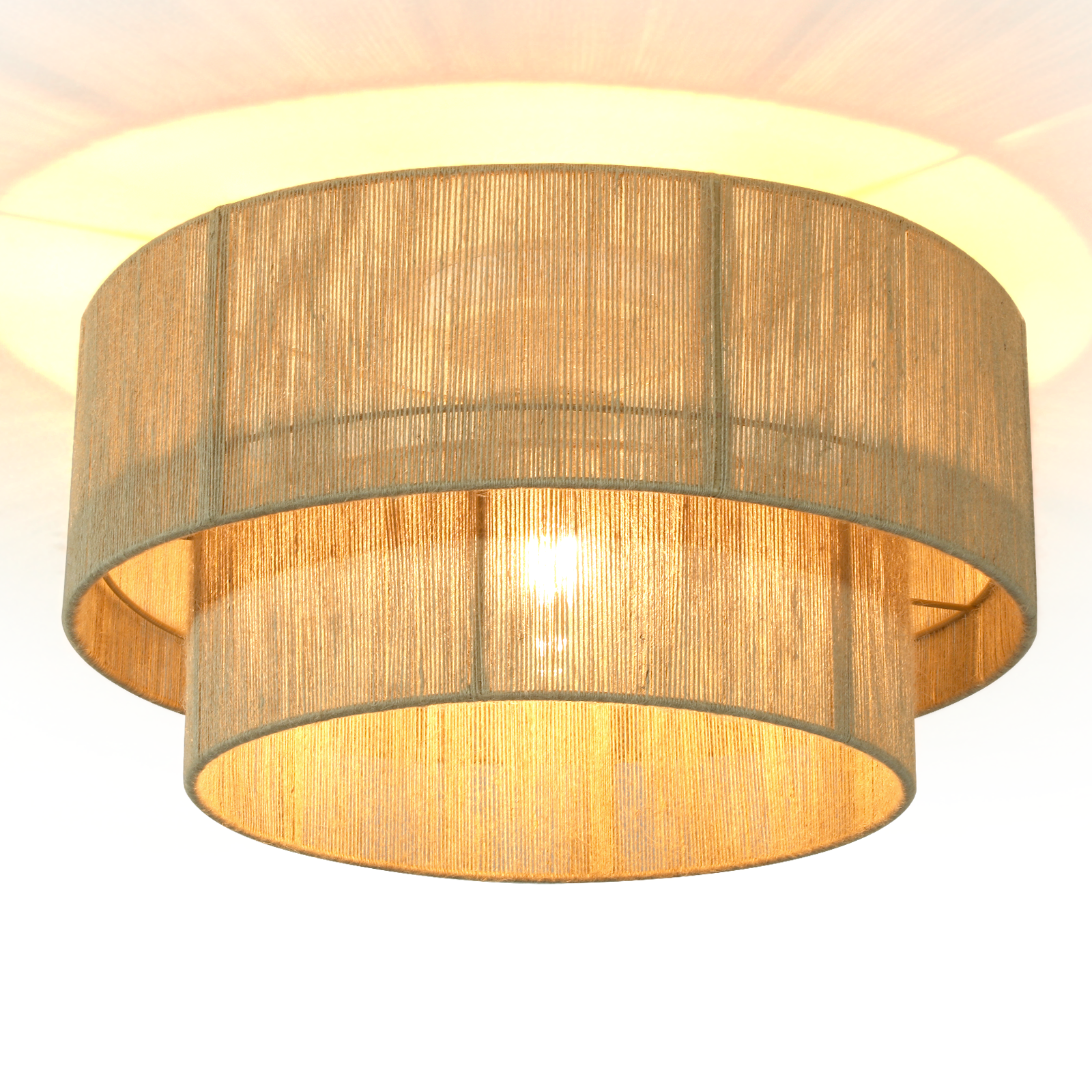 Lampada a due livelli con paralume in corda di iuta, illuminata dall'interno.