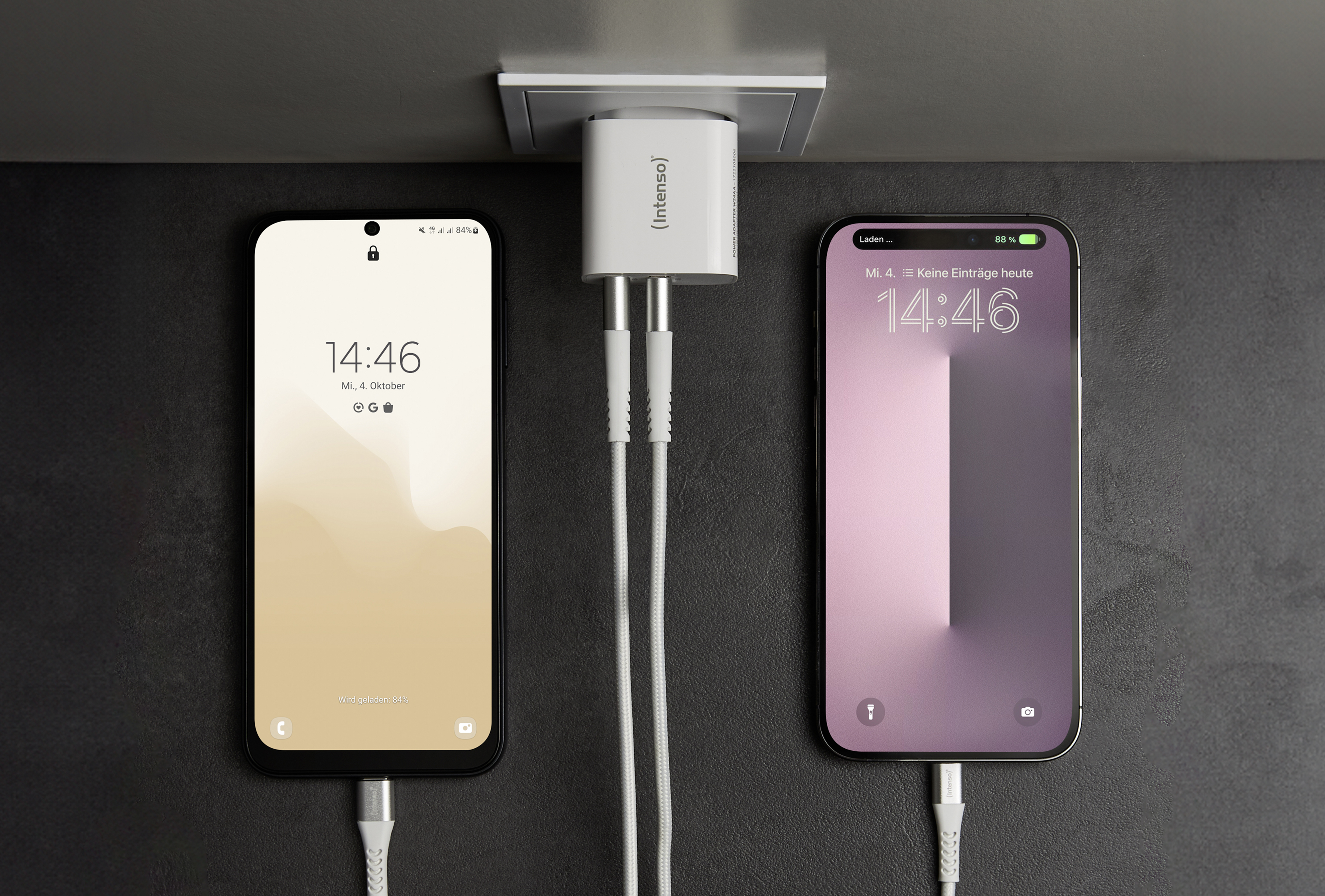 Two smartphones are plugged into a white power adapter.