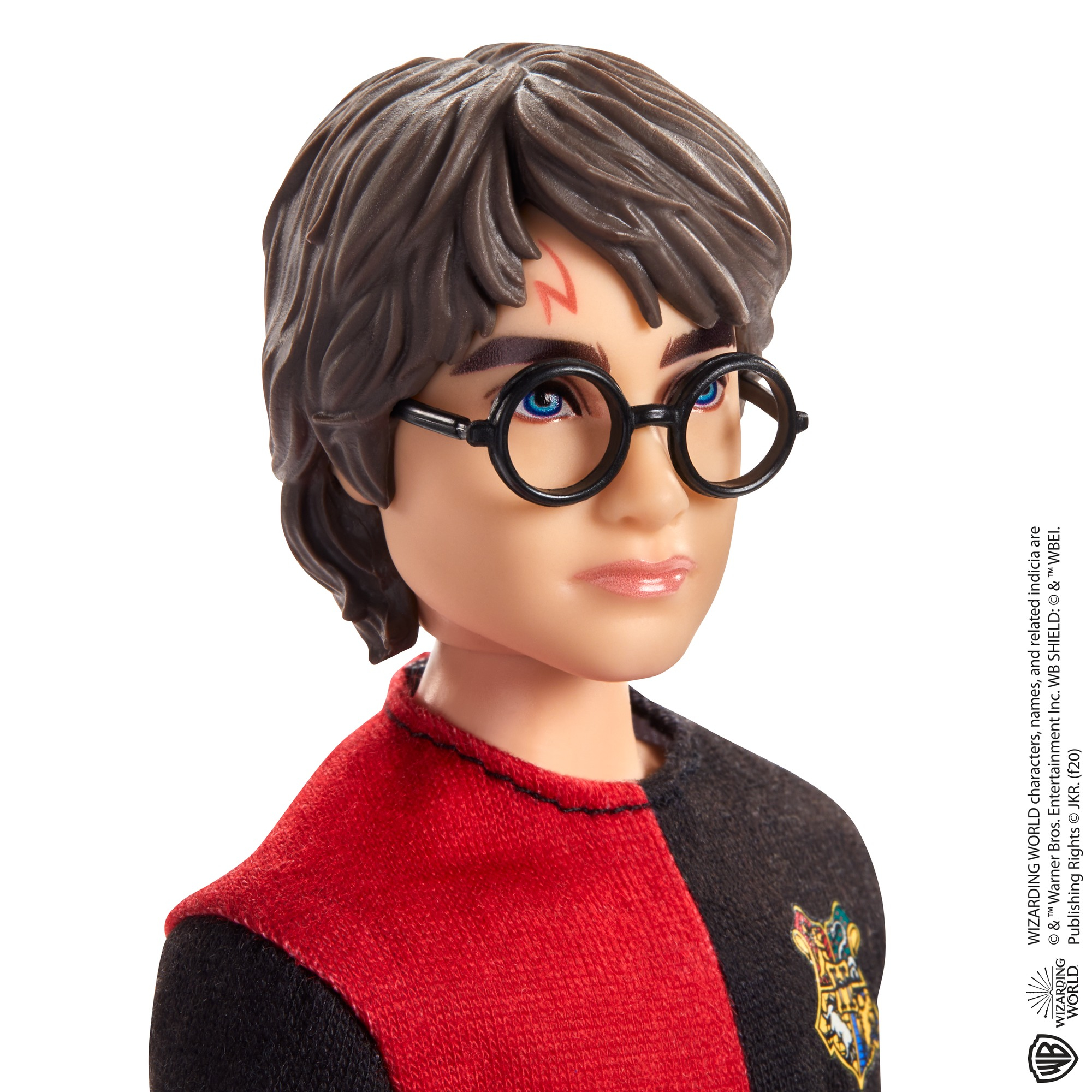 Bambola di Harry Potter con cicatrice, occhiali e stemma Grifondoro.