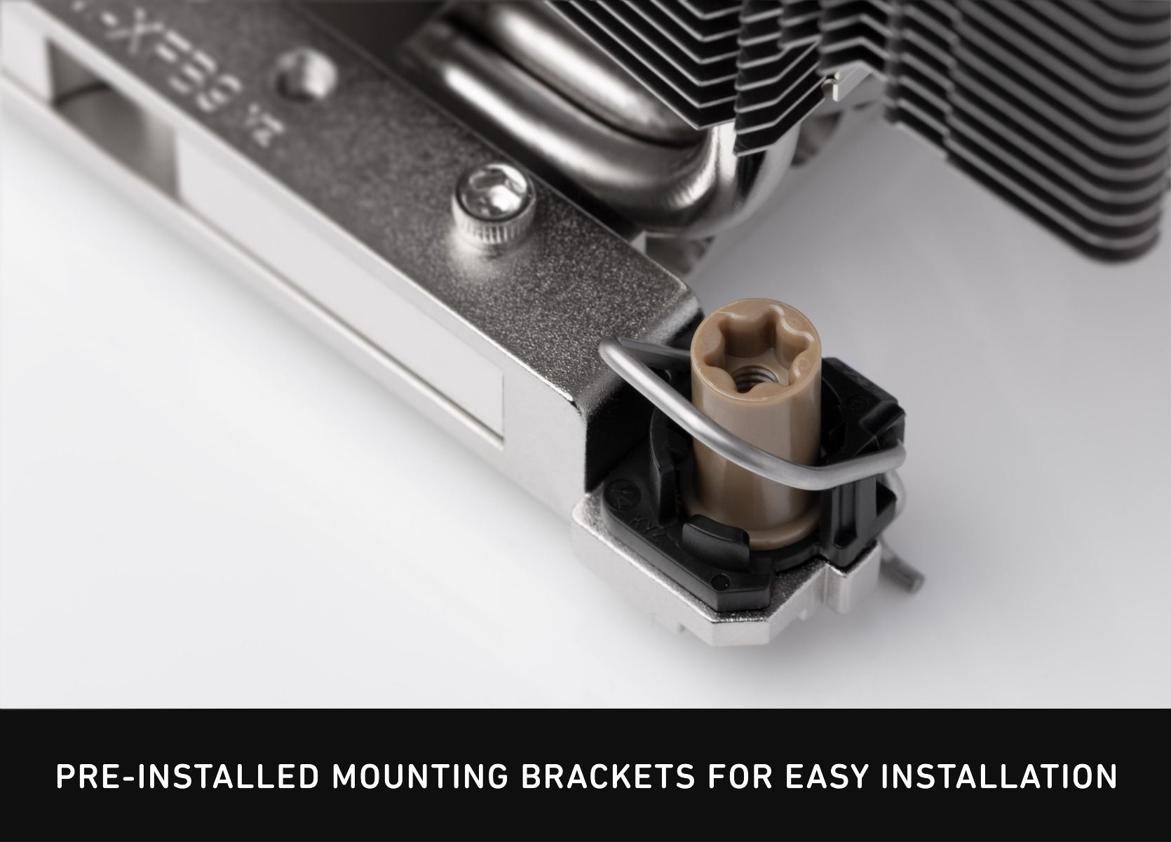 Close-up of CPU cooler mount with beige-brown pin and metal bracket.