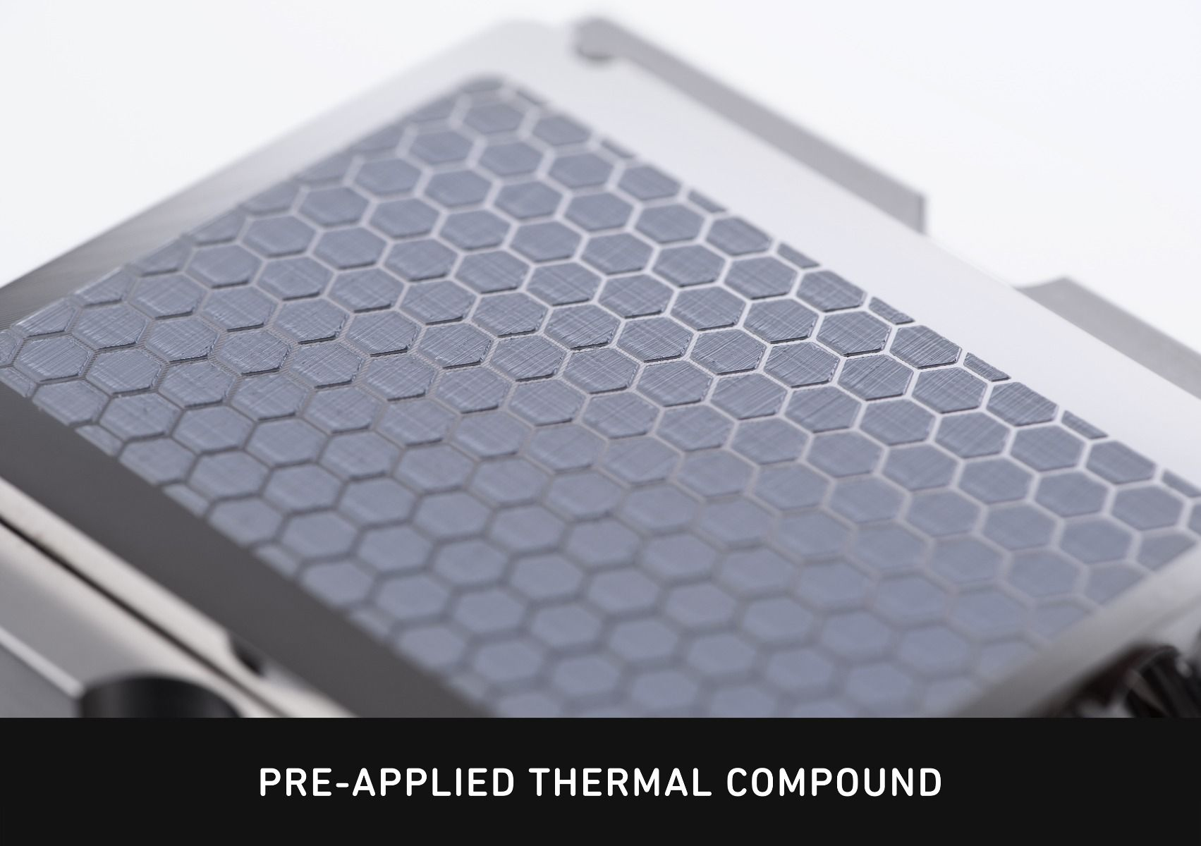 Gray honeycomb pattern on a metallic surface, close-up.