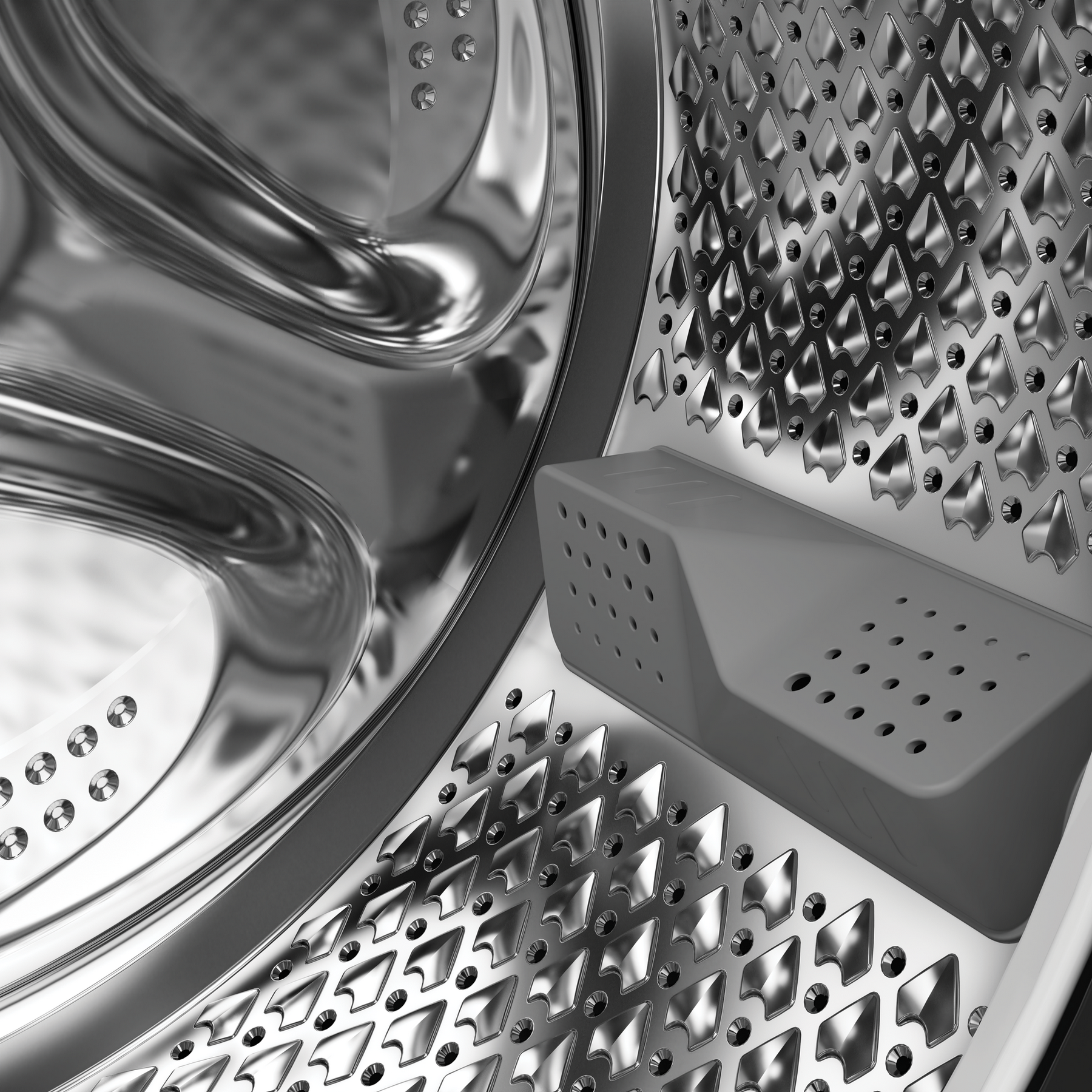 Interno di un cestello di lavatrice con superfici metalliche lisce e curve e lati perforati.