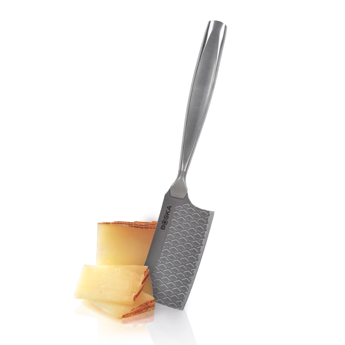 A Boska cheese grater with cheese pieces, on a white background.