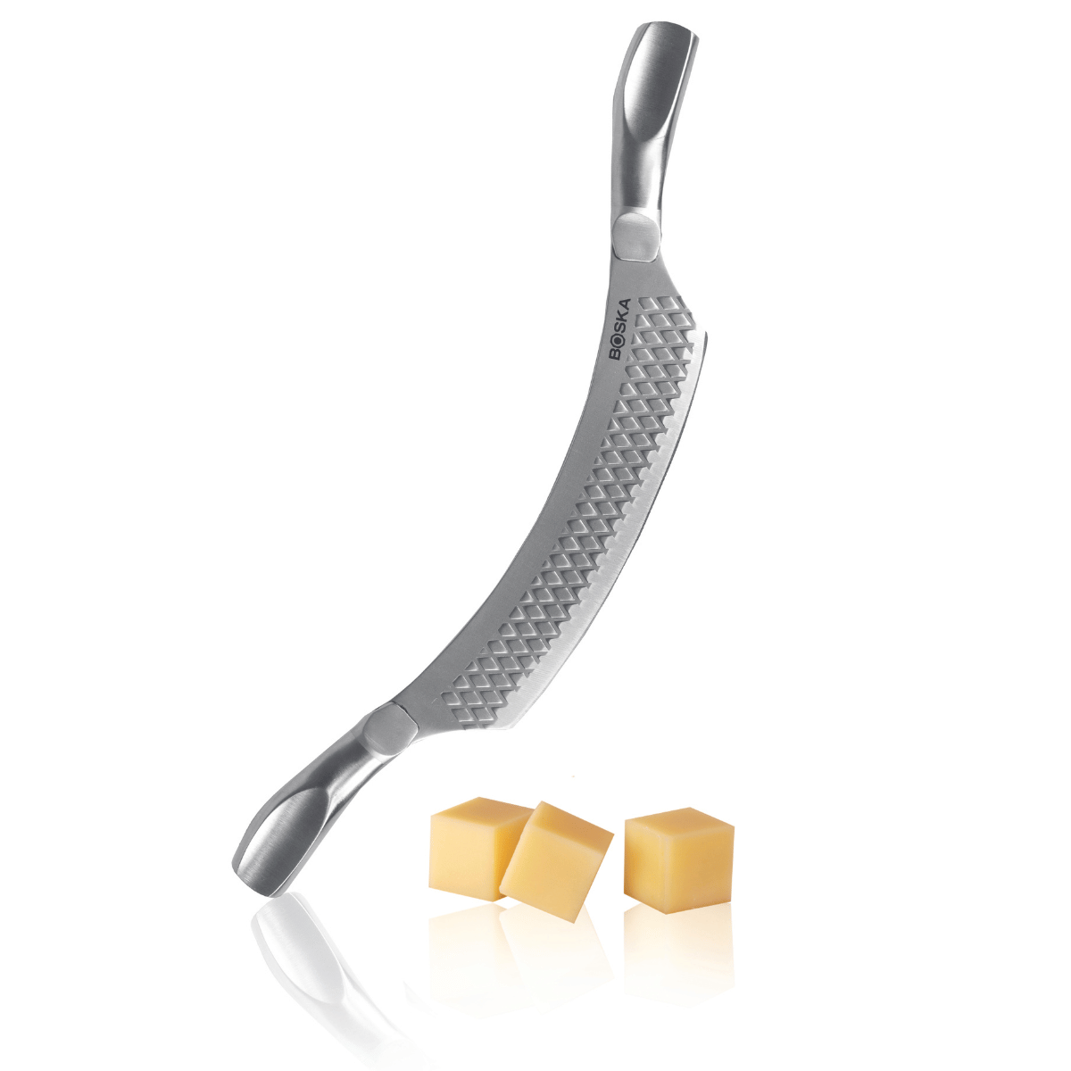 A curved cheese knife with a diamond pattern and three cheese cubes.