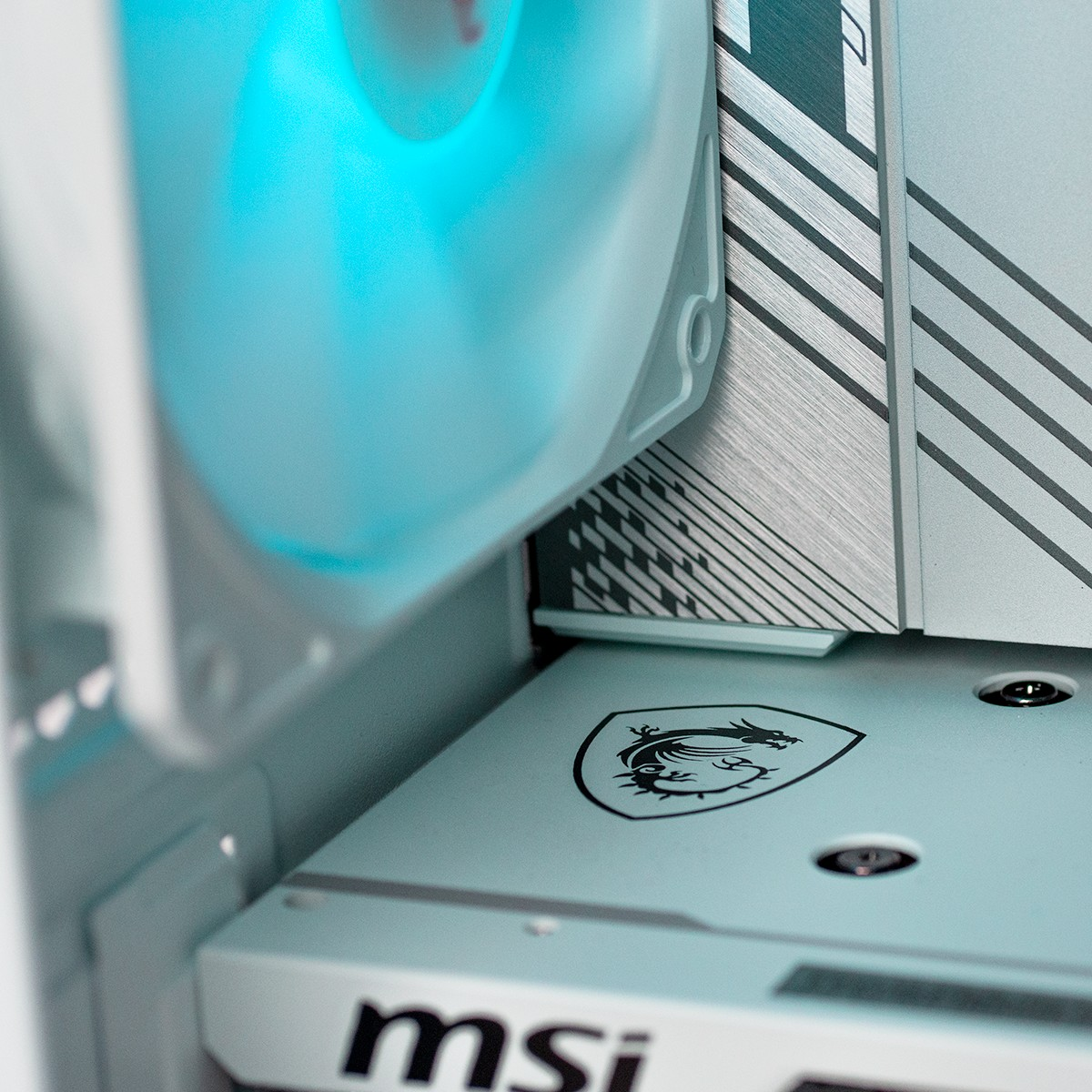 A computer fan with blue light above an MSI logo and circuit board.