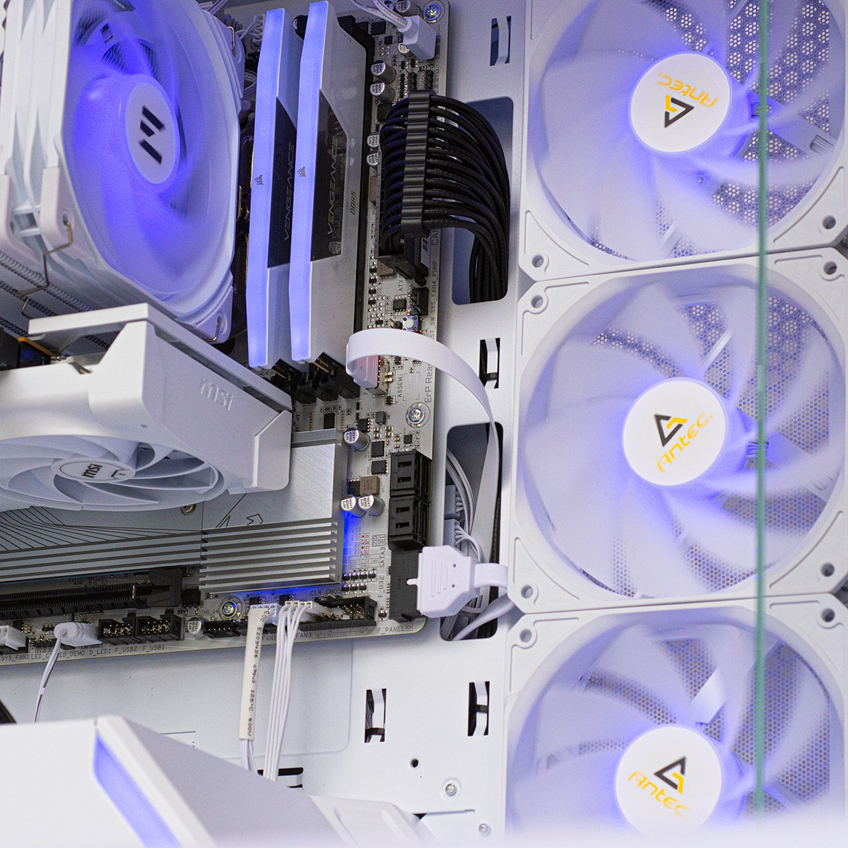 An open computer case with blue fans and white hardware.