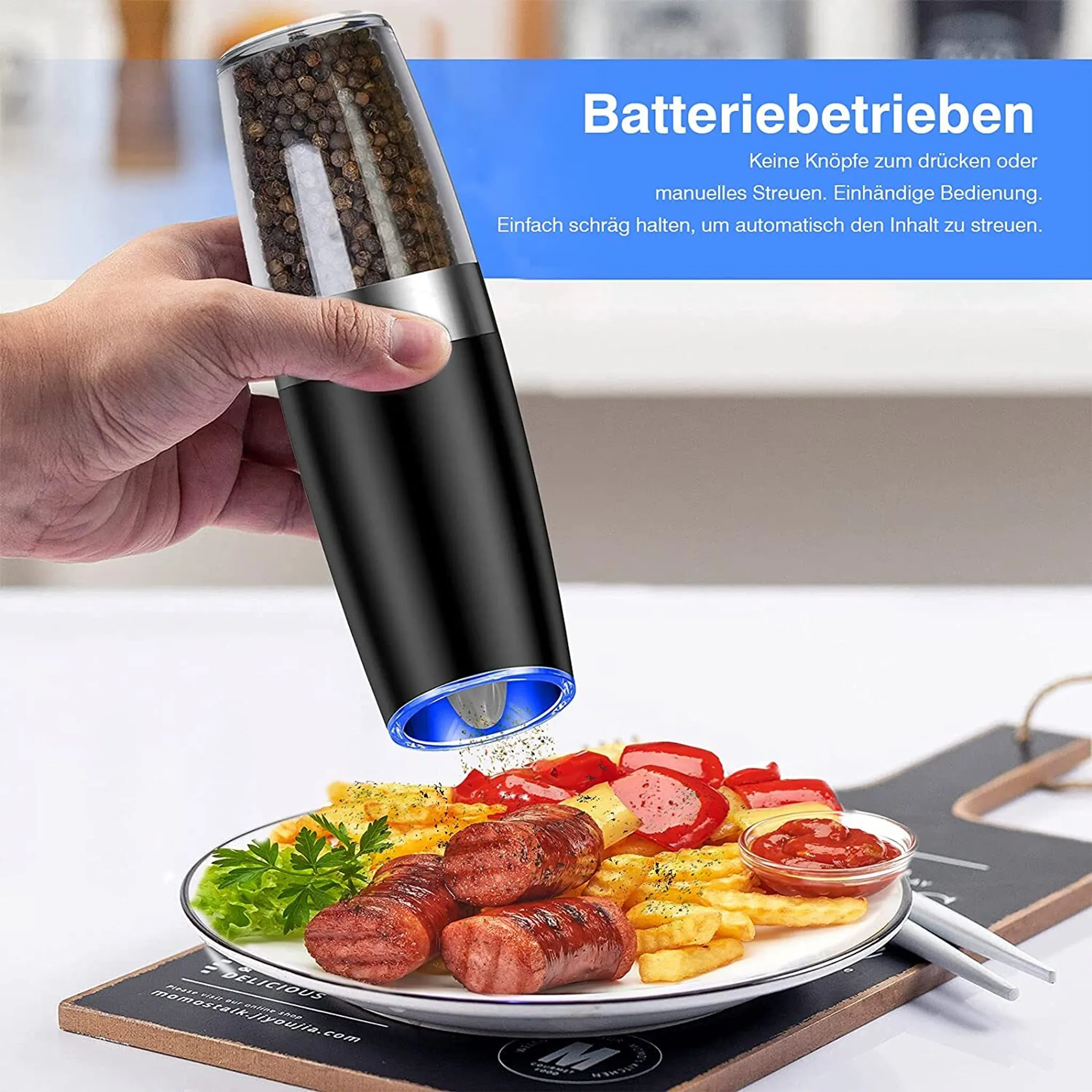 Elektrische Pfeffermühle mahlt Gewürze über Essen.