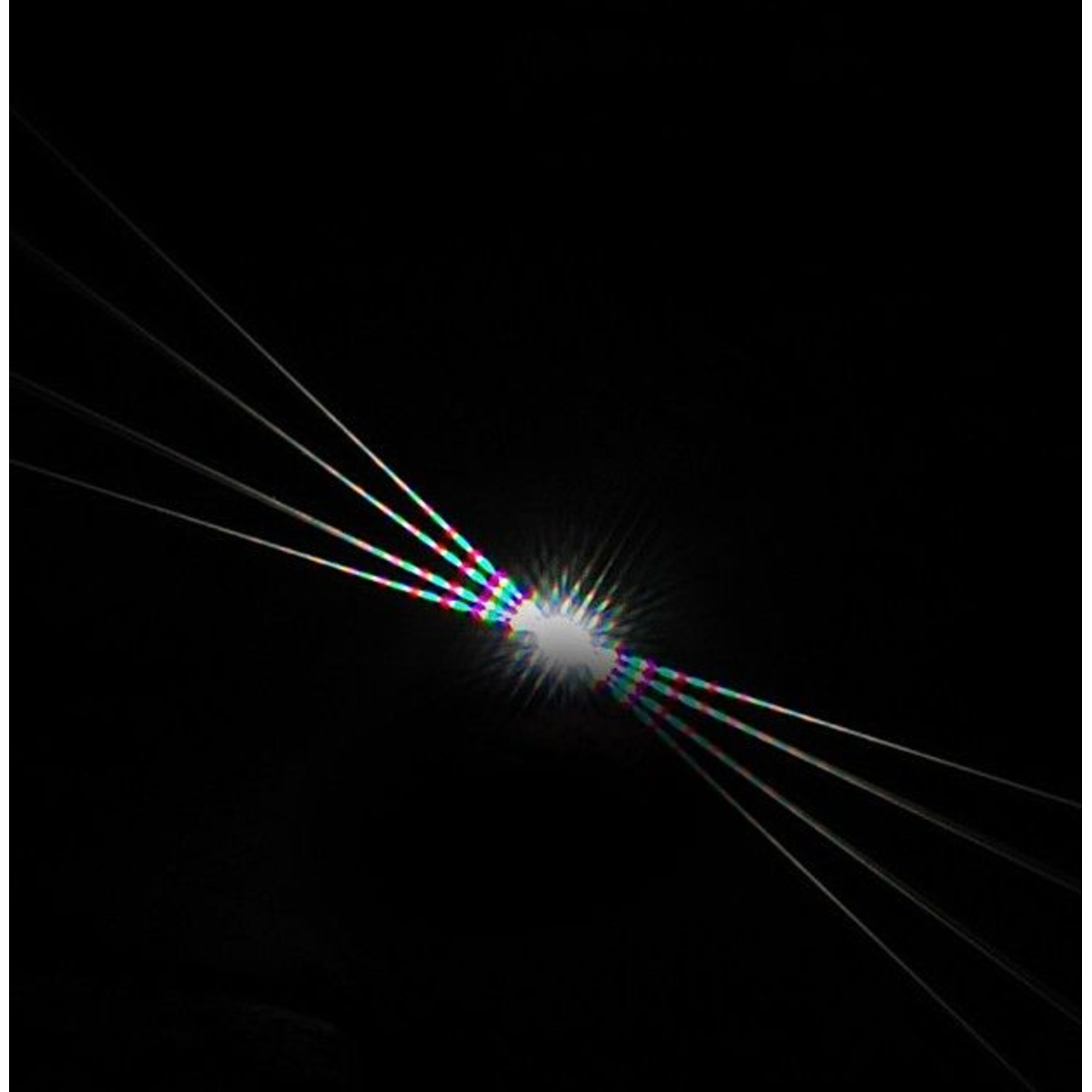 Lichtstrahlen breiten sich von einem hellen Zentrum auf schwarzem Hintergrund aus.